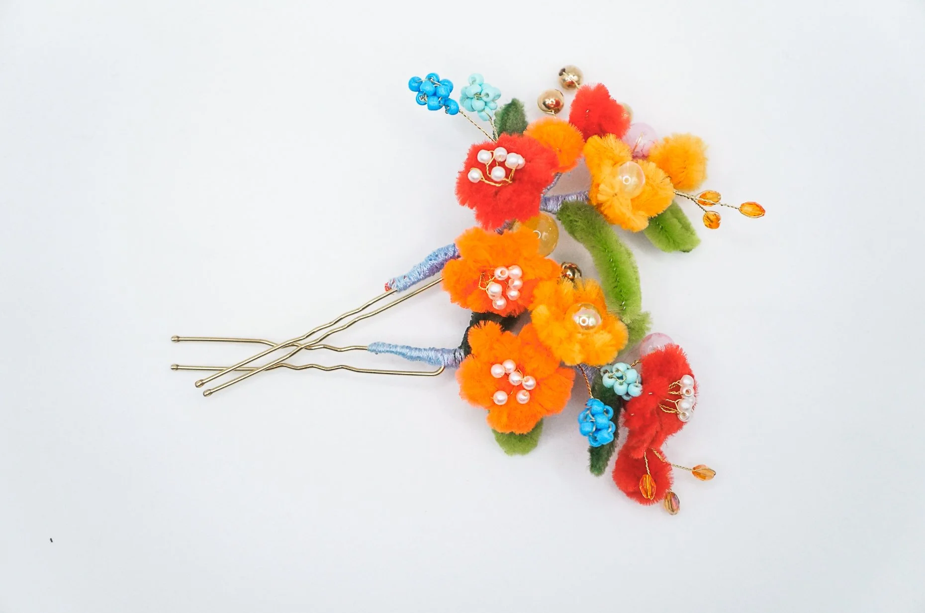Mini bouquet bridal hair pins made with red and orange silk flowers on a bridal-style golden U-pin base with various glass and acrylic beads. Perfect for the upcoming winter season!