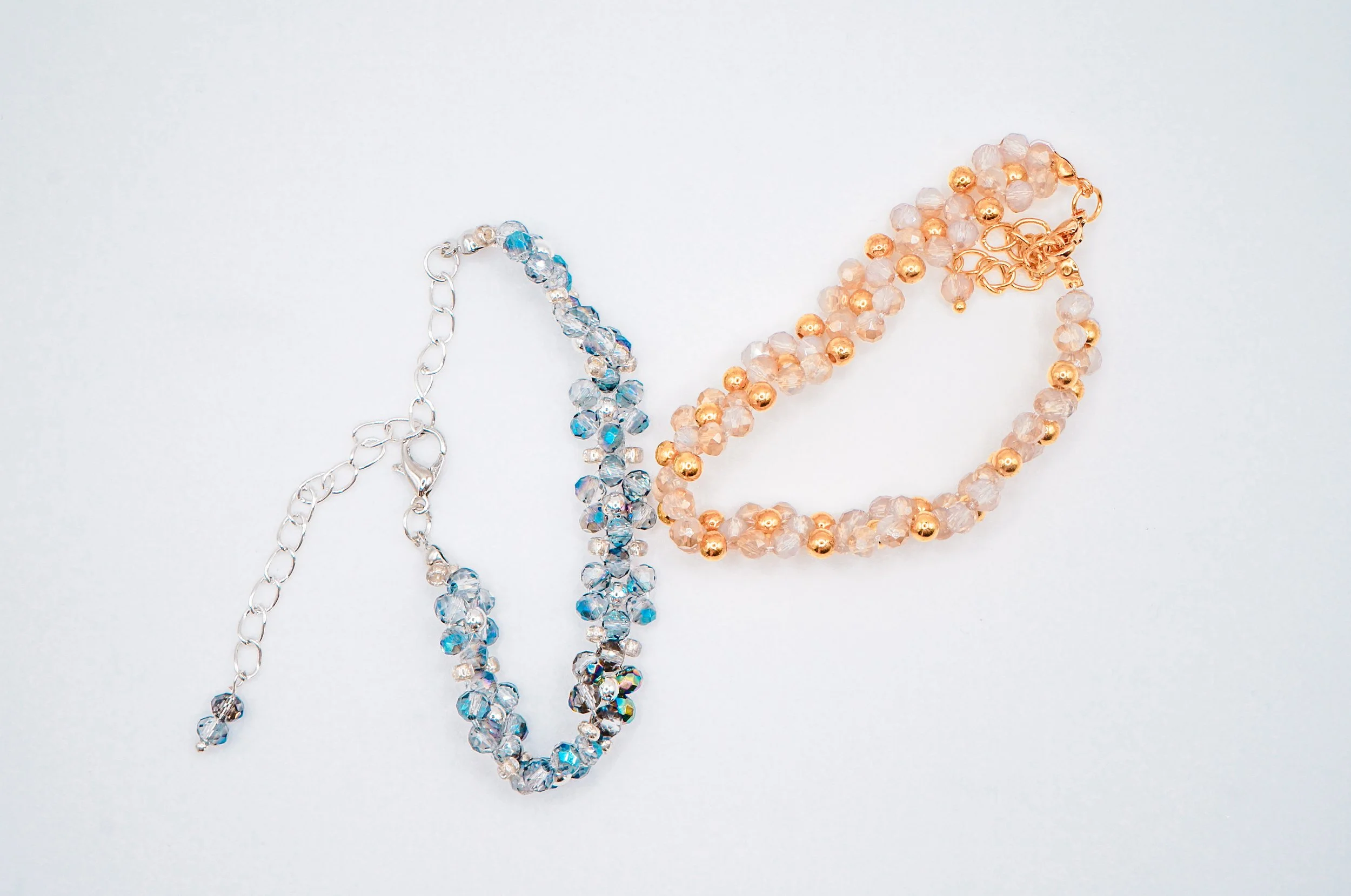 A set of glittering hand-beaded bracelets for formal dress occassions with gold and silver holographic beads and high quality metal beads (top view)