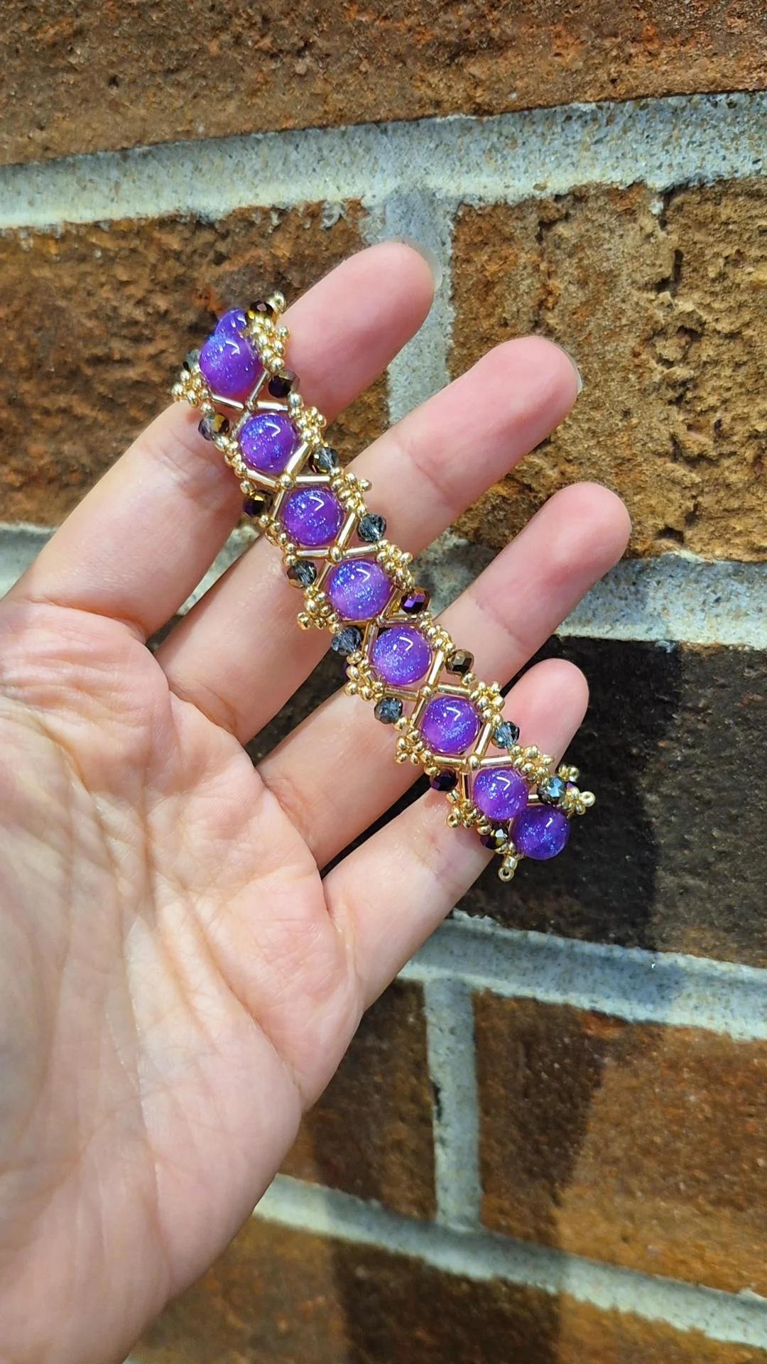 mystical witch vibe beaded bracelet with gold rods and glittering purple resin beads