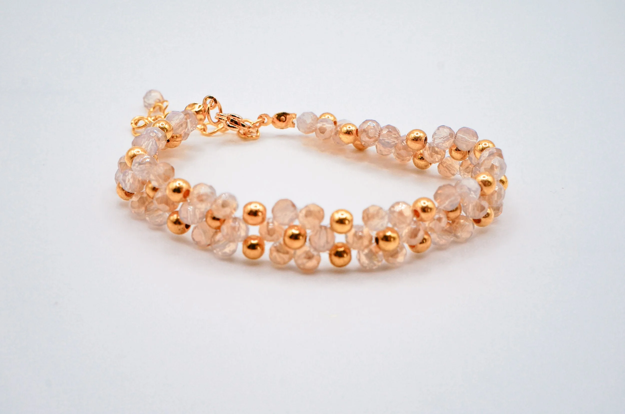 A golden hand-beaded bracelets for formal dress occassions with gold holographic beads and high quality metal beads