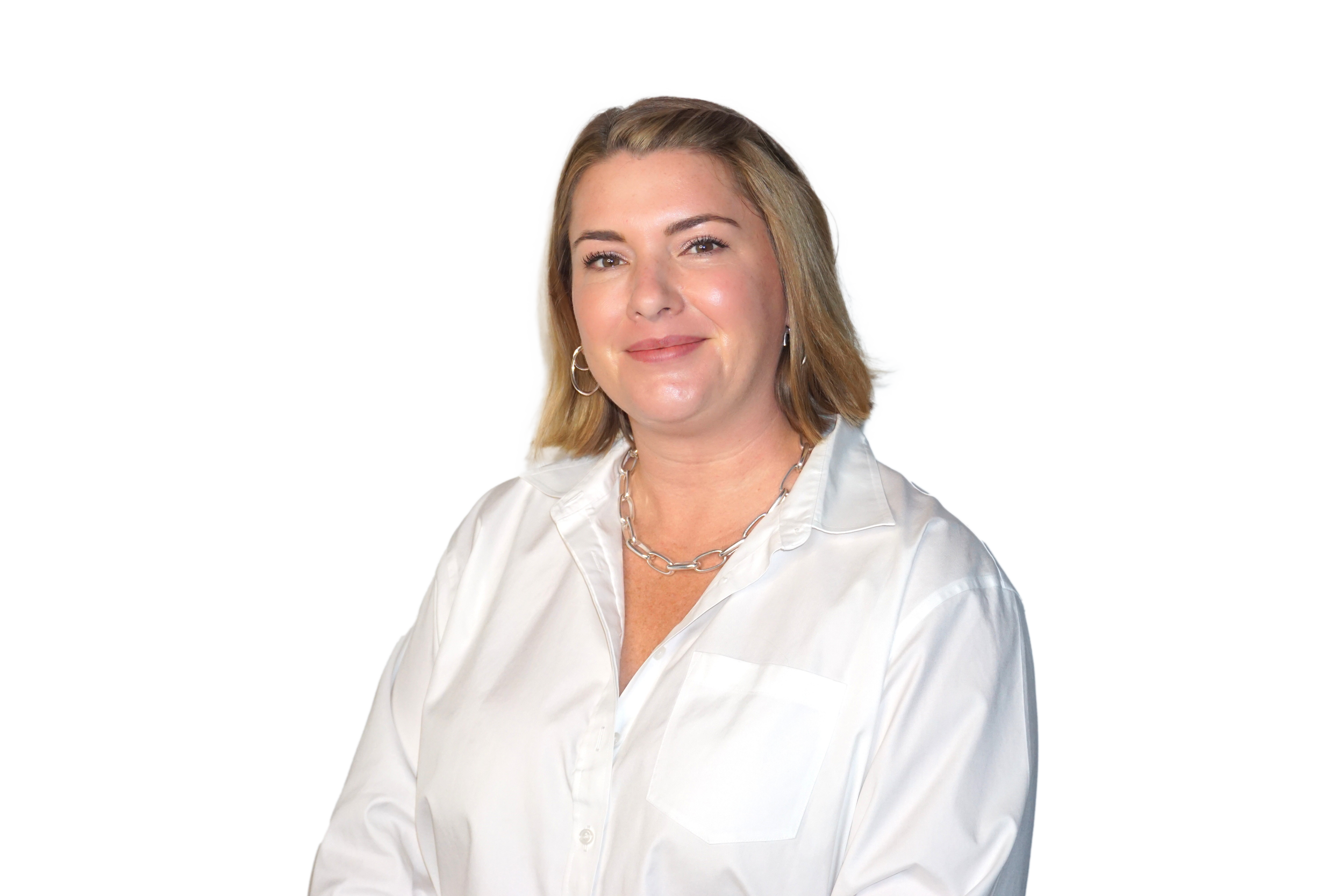 A smiling woman with blonde hair wearing a gray blazer and white blouse, posing with her arms crossed.