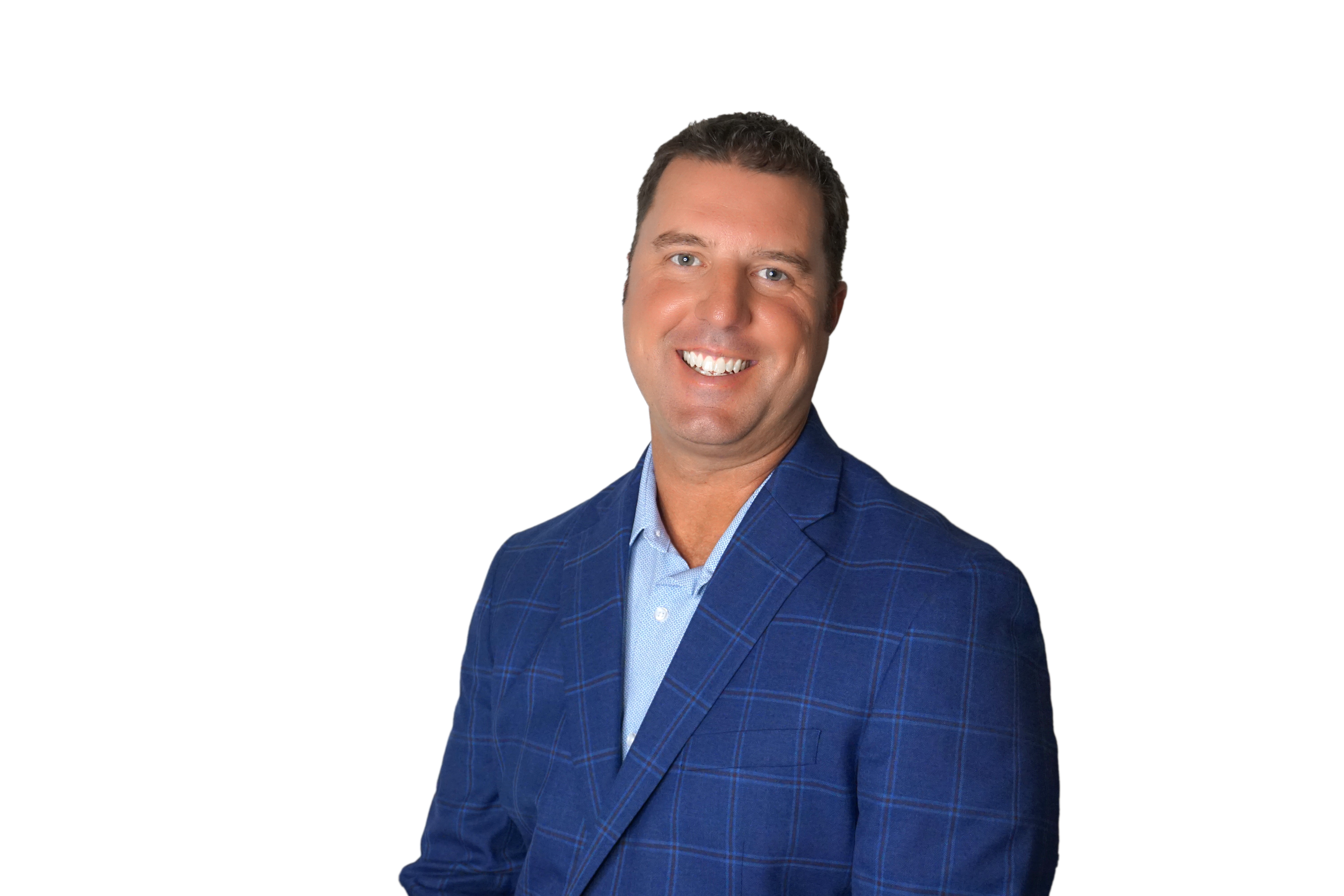 A man with short brown hair wearing a blue suit jacket and a matching checkered shirt, smiling against a white background.