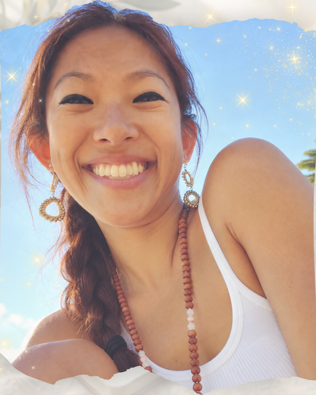 A woman smiling on the beach.