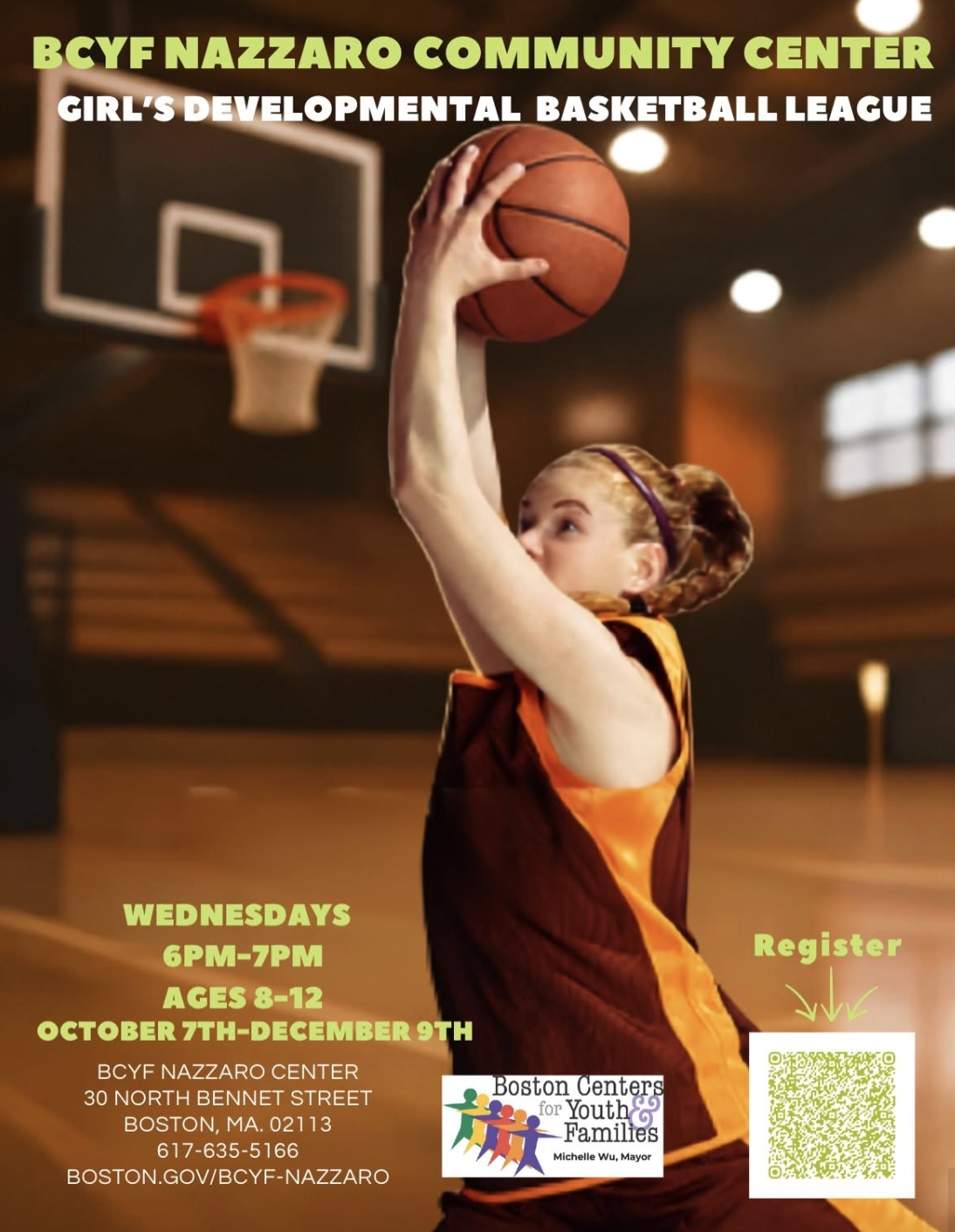 A young girl in a basketball uniform preparing to shoot a basketball in an indoor gym.