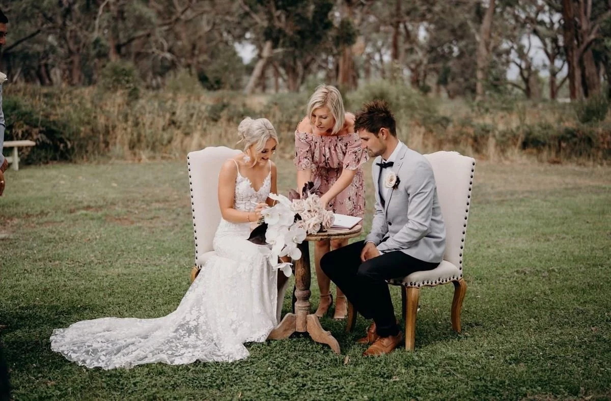 Wedding Celebrant With A Couple Signing The Legal Documents