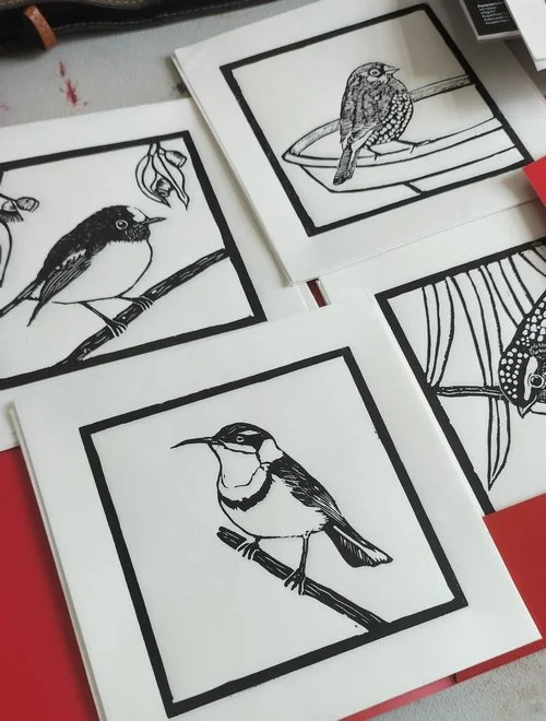 Black and white line drawings of various birds on paper