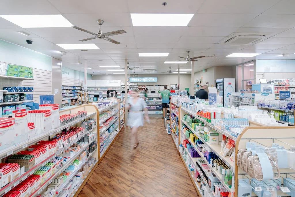 Inside Broome Pharmacy with a range of medical products and a view of the dispensary.