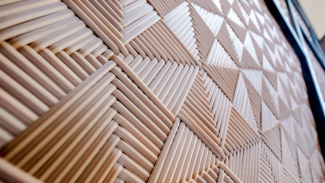 Close-up of a woven wicker surface with a geometric pattern.