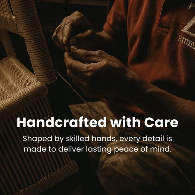 Close-up of a person's hands working on a handcrafted item in a dimly lit setting.