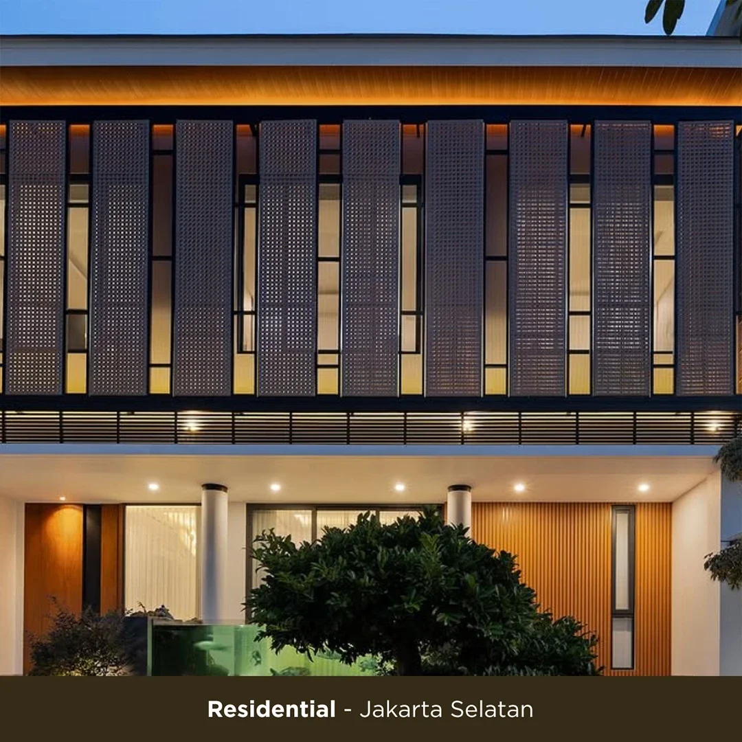 Modern residential building in South Jakarta with a well-lit facade, large windows, and decorative wood panels.