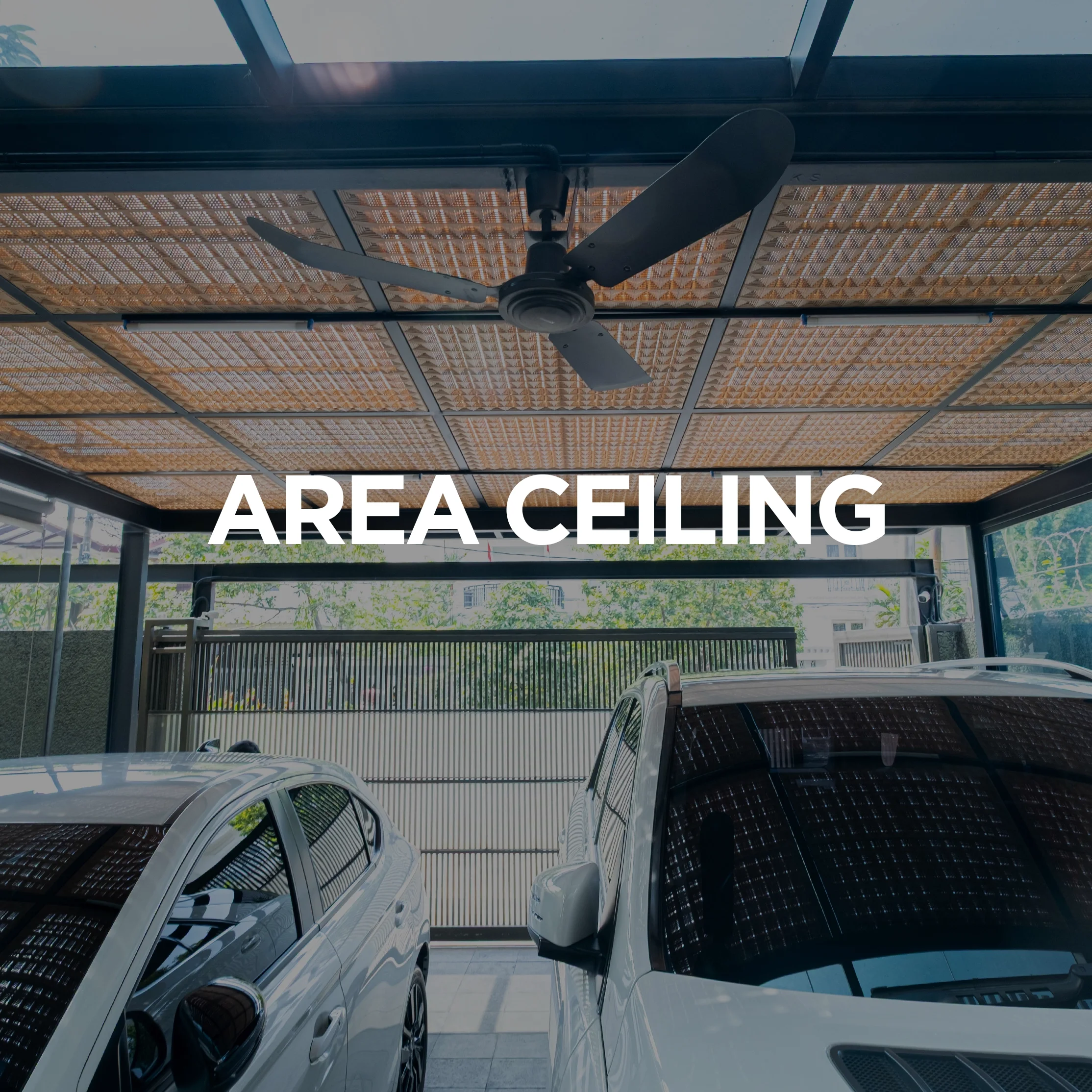 Indoor parking area with cars, ceiling fan, area ceiling with wooden panels, large glass windows, and sliding gate in the background.