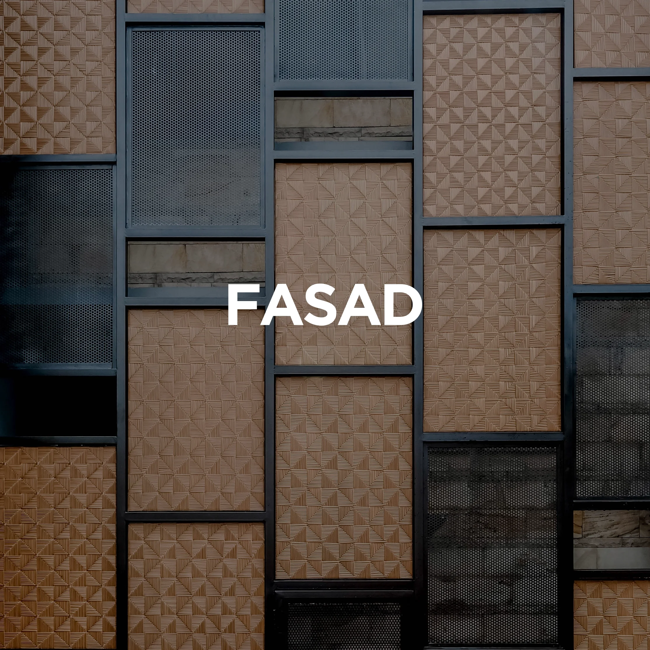 Close-up of a modern building facade with various textured panels and metal frames. The word 'FASAD' is centered in white text.