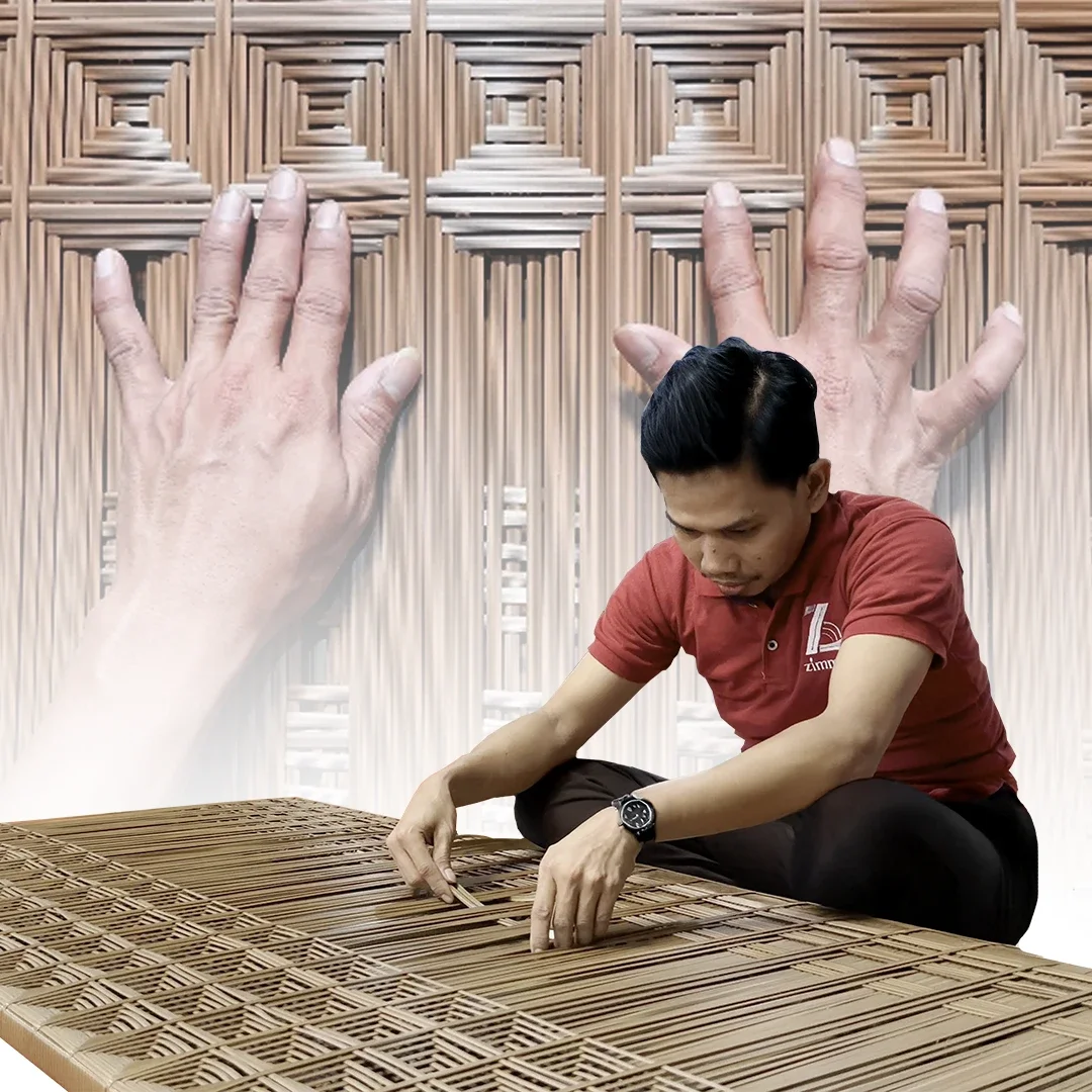 A man working on weaving a bamboo mat with large hands and a backdrop of a similar hand-woven bamboo pattern.