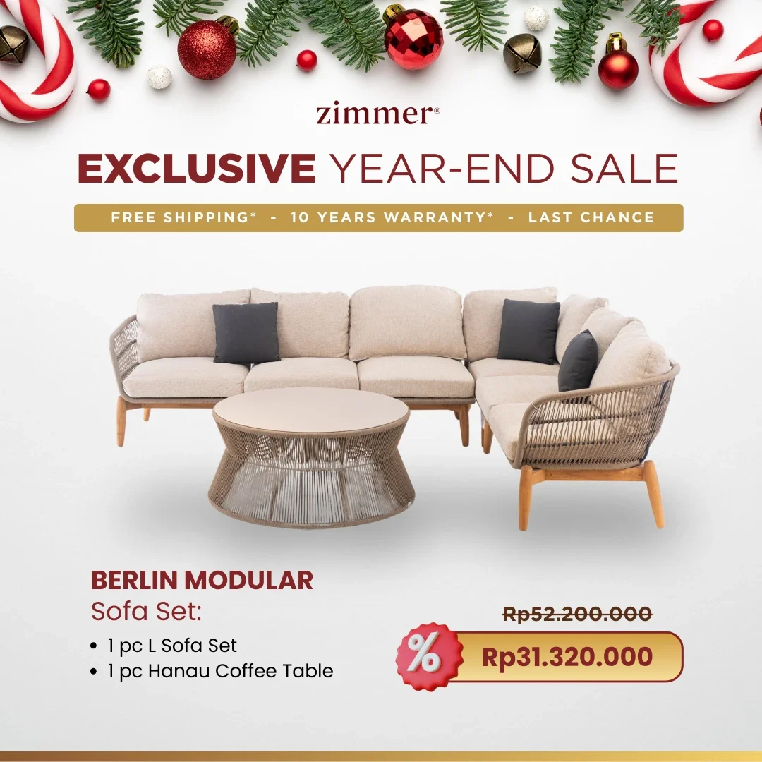 A Christmas-themed advertisement for Zimmer's exclusive year-end sale featuring a beige modular sofa set called Berlin Modular, accompanied by a coffee table. Decorated with festive ornaments and pine branches at the top, with discounted pricing high