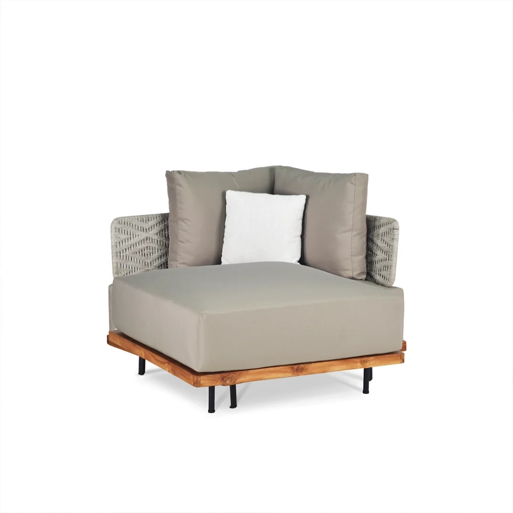 Modern beige armchair with wooden base and black legs, featuring patterned fabric side panels and beige cushions, set against a white background.