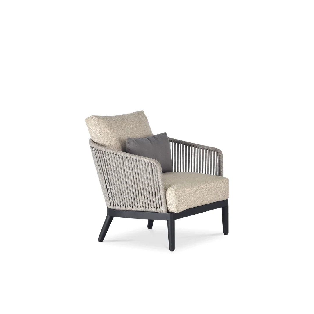 Modern armchair with beige cushions, black wooden legs, and grey side pillows, isolated on white background.