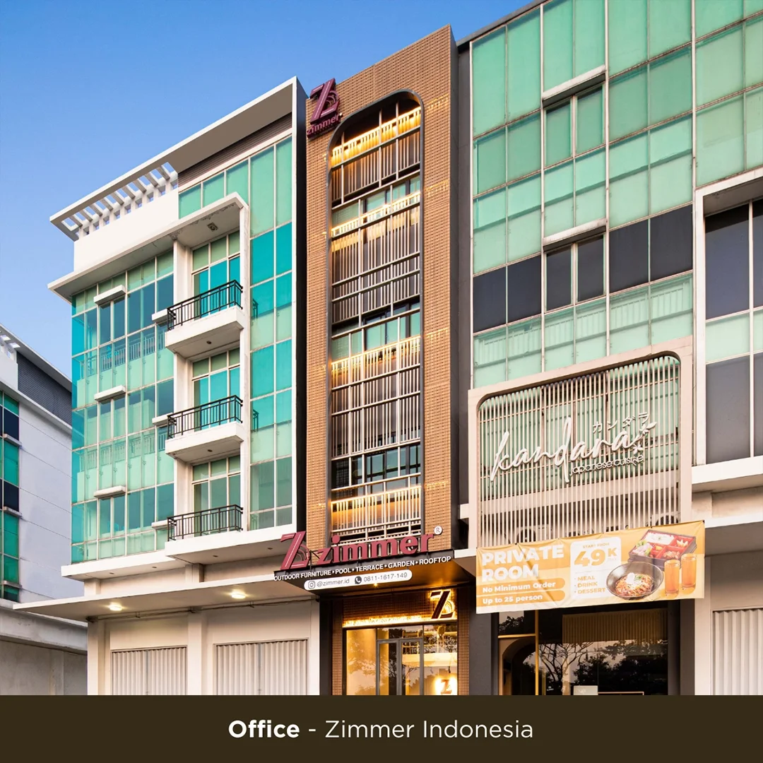 A modern multi-story office building with glass windows, balconies, and signage for Zimmerman Indonesia, featuring a red and white sign, and a banner advertising a private room with meal, drink, and dessert options.