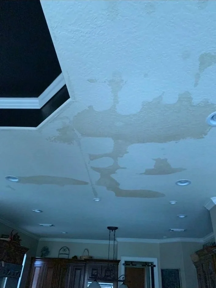 Peeling ceiling paint and damaged finish inside a home