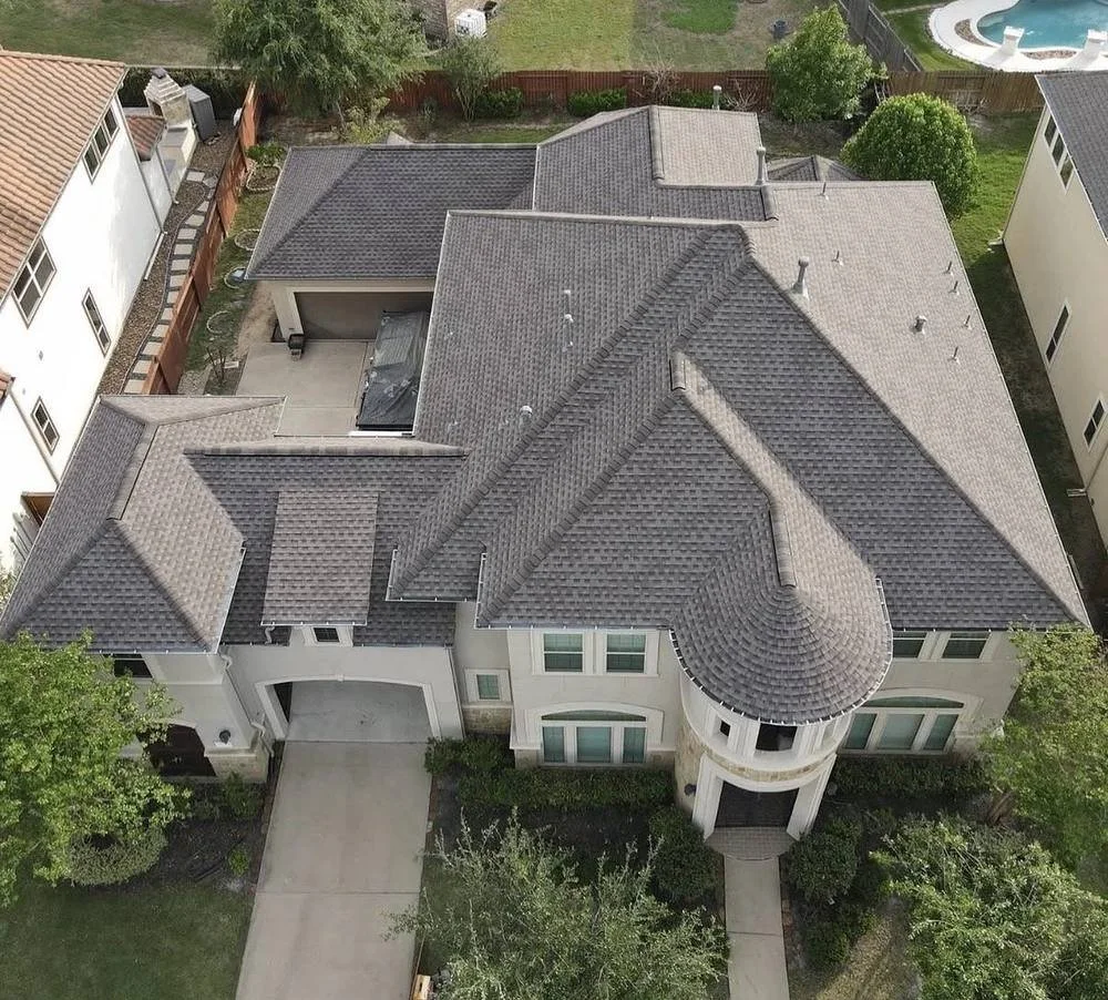 Aerial view of a completed GAF Timberline HDZ roof replacement by Apex Roofing Solutions in Katy, Texas.