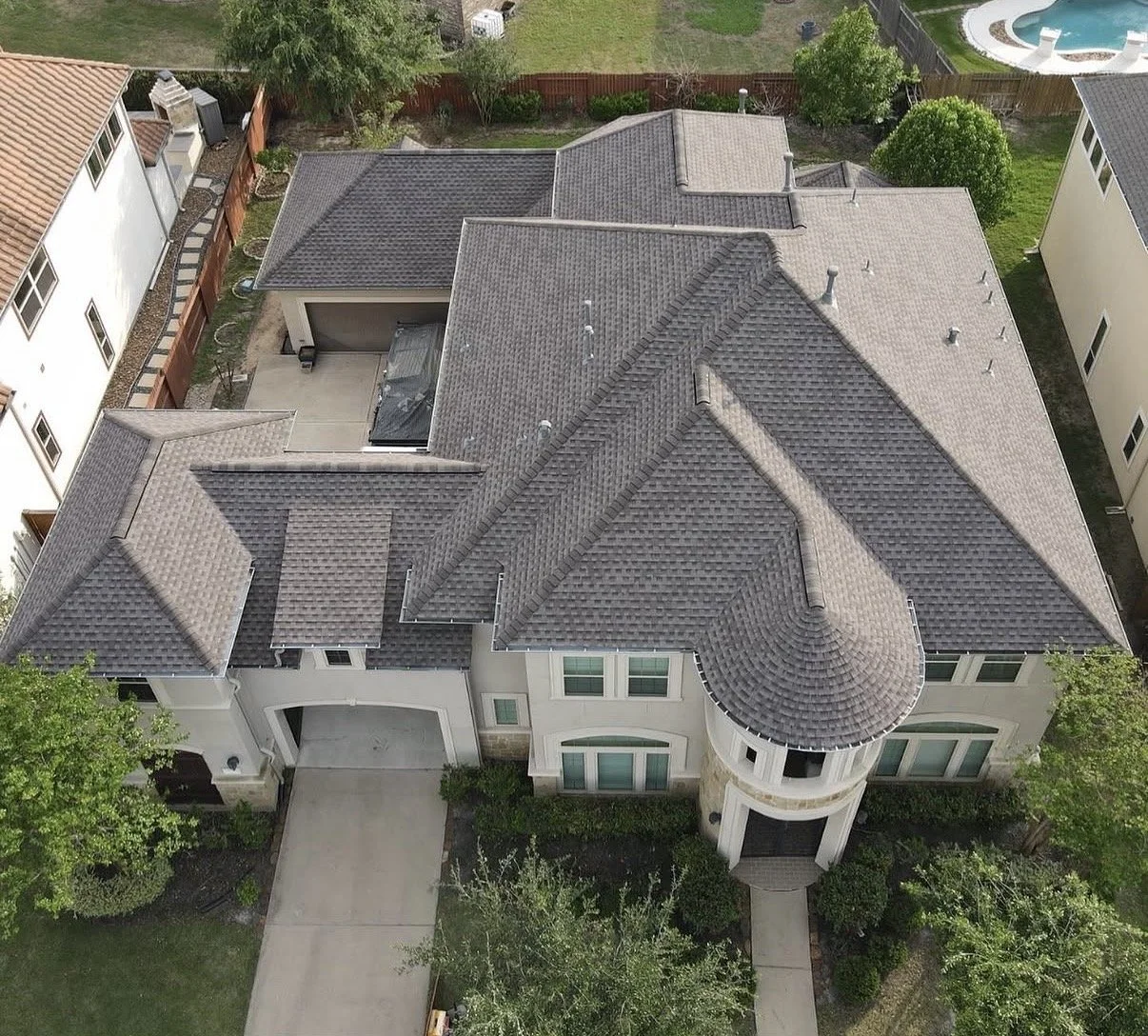 Aerial view of a completed residential roof replacement by Apex Roofing Solutions in the Greater Houston area.