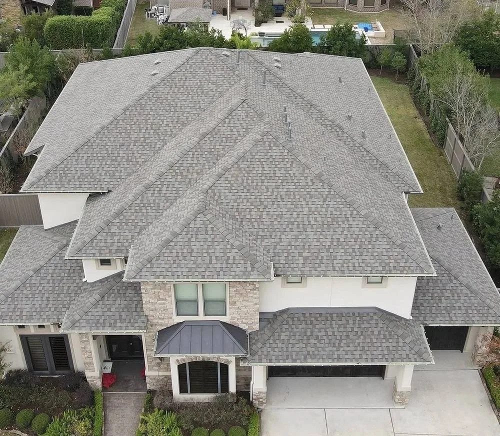 Aerial view of a completed Owens Corning Duration roof replacement by Apex Roofing Solutions in Cypress, Texas.