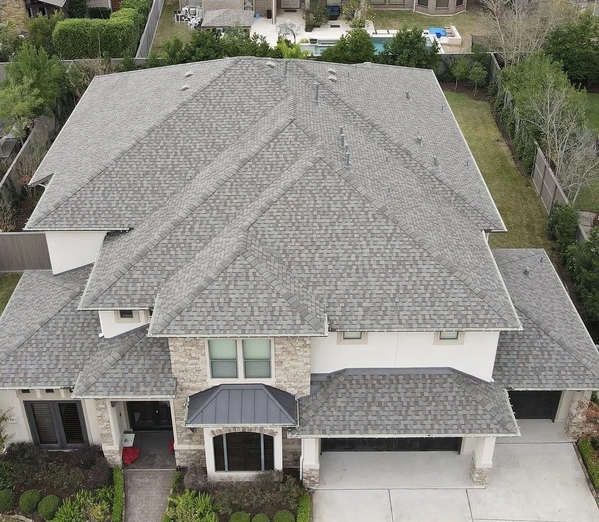 Aerial view of a completed residential roof replacement by Apex Roofing Solutions in the Katy area using Owens Corning Duration shingles.