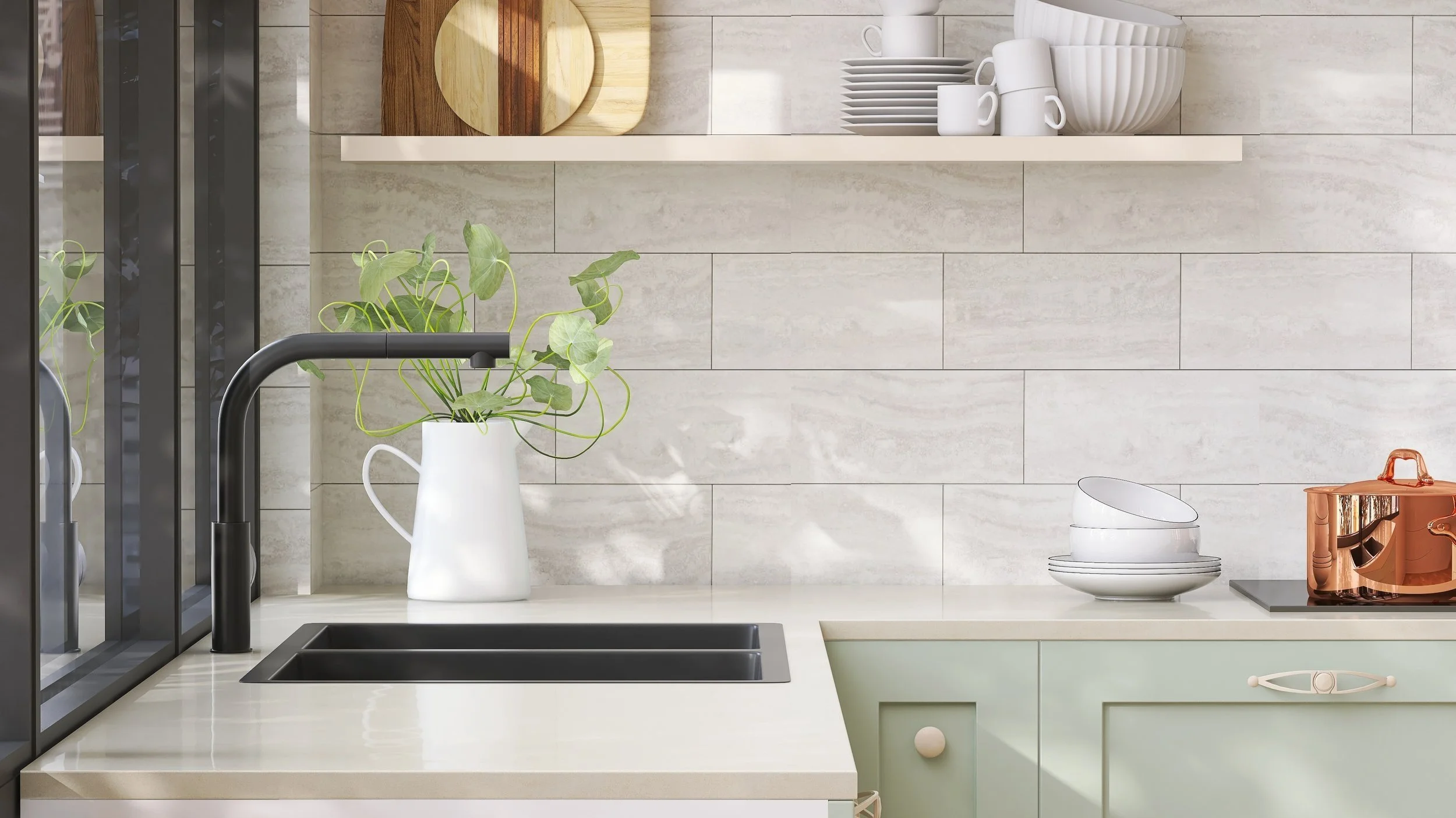 Modern kitchen countertop with black sink, faucet, white vase with green plant, white dishes, and a copper pot, against a beige tile backsplash.