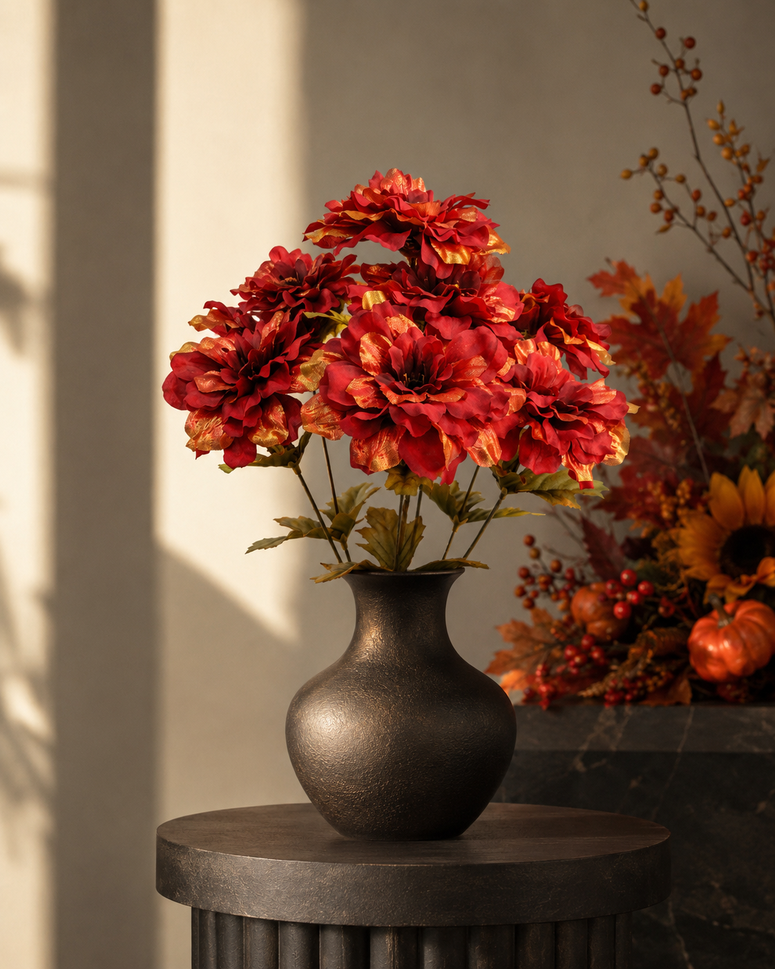 Artificial red and gold dahlia arrangement in dark vase for autumn home decor