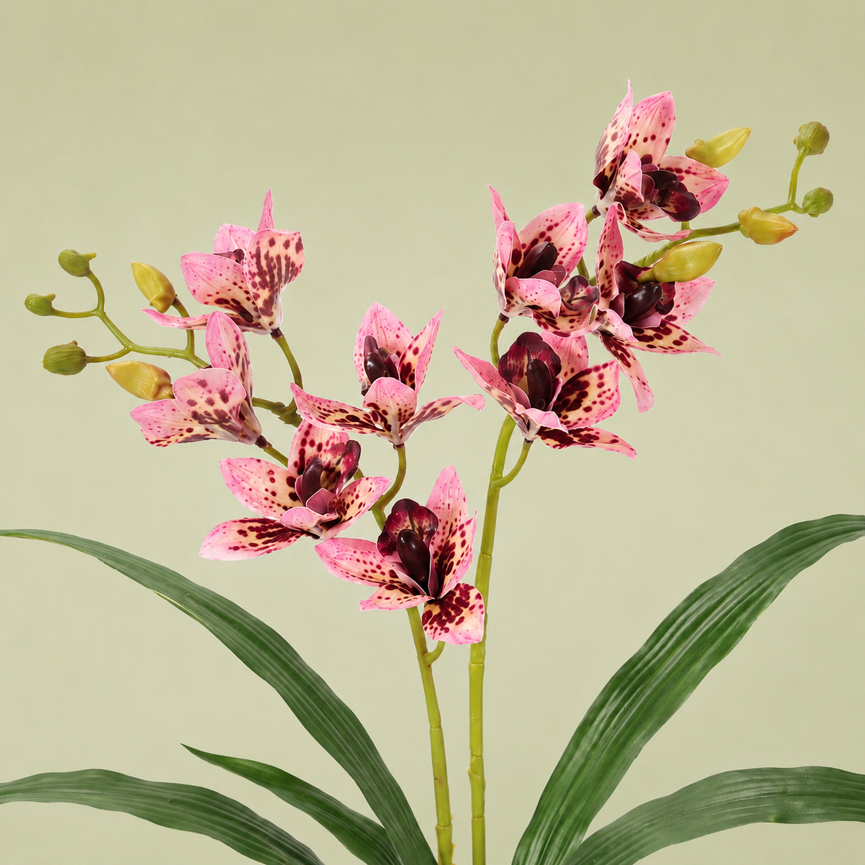 Artificial pink tiger orchid stem with spotted petals and greenery