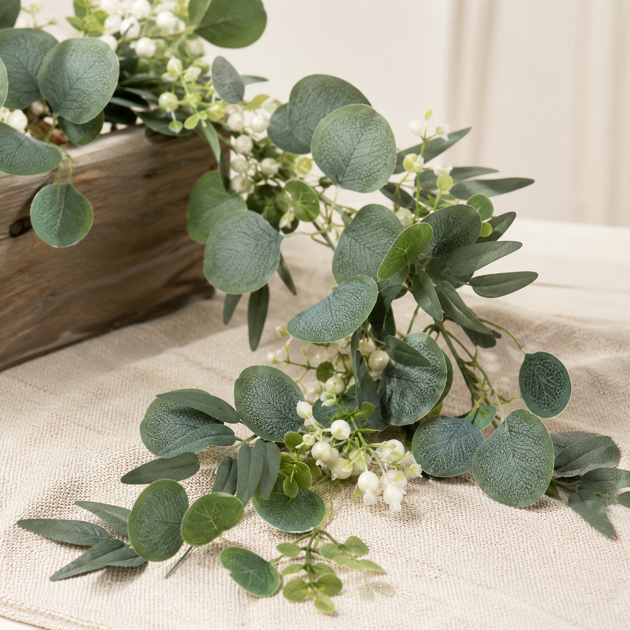 Artificial eucalyptus garland with realistic green leaves and delicate white accents for decorative displays