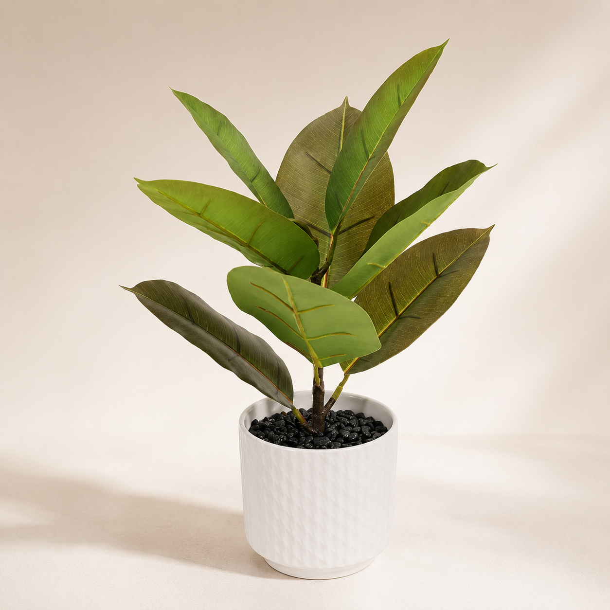 Artificial strelitzia plant in a white planter with realistic tropical green leaves for interior décor