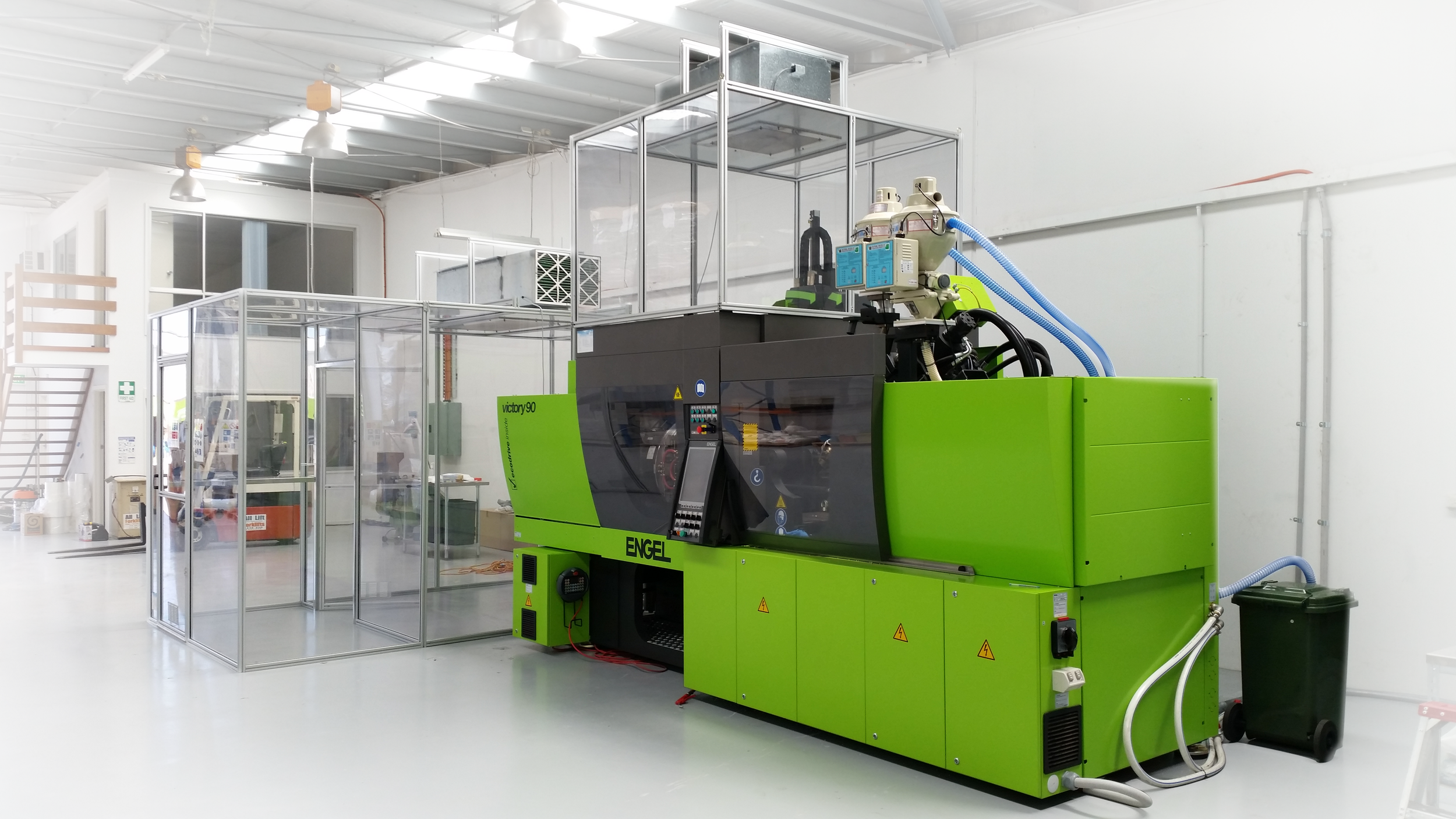 Close-up of a CNC machine tool drilling into a metal part in a manufacturing setting.