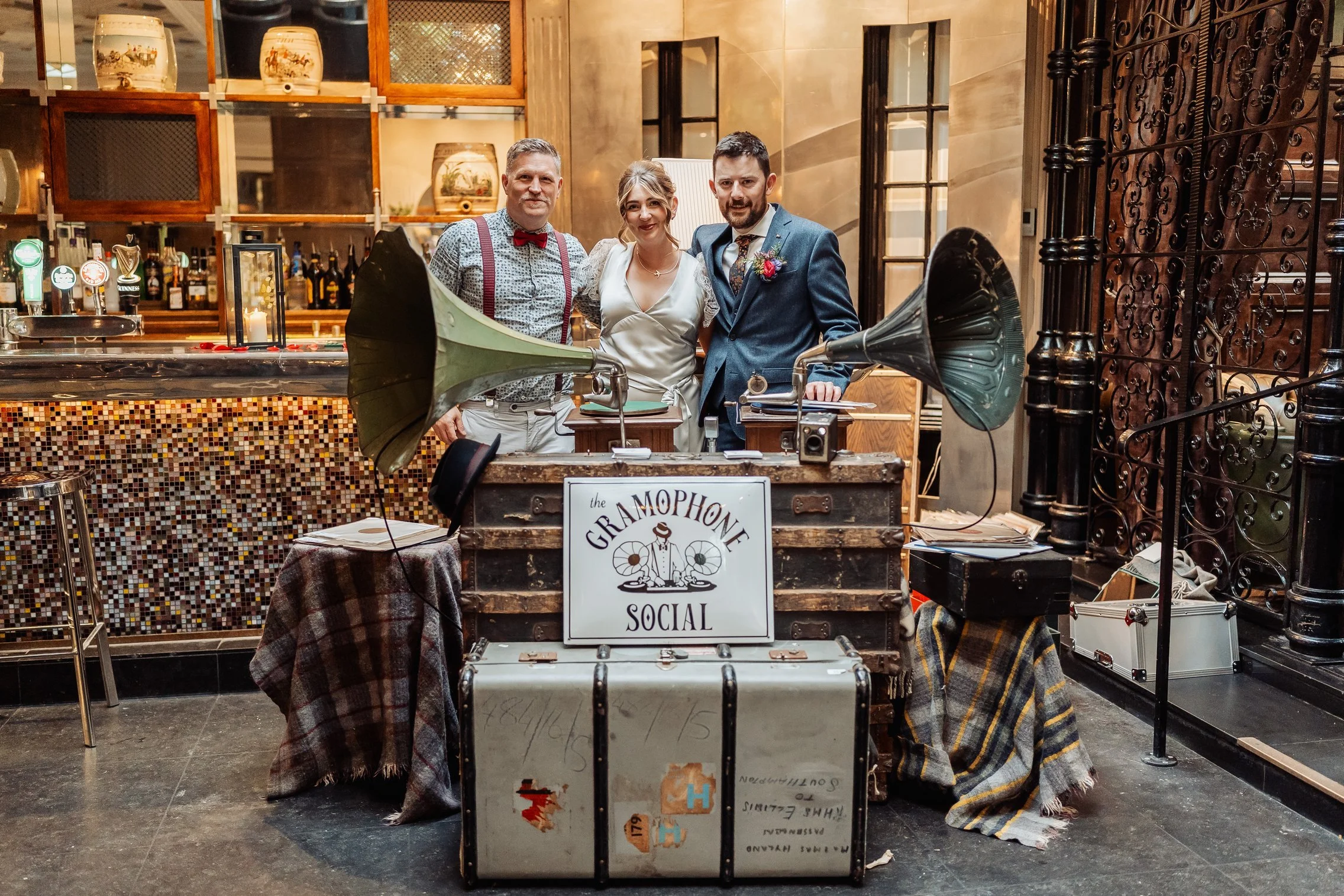Trevor from The Gramophone Social posing with wedding couple Jeanne and Robert.