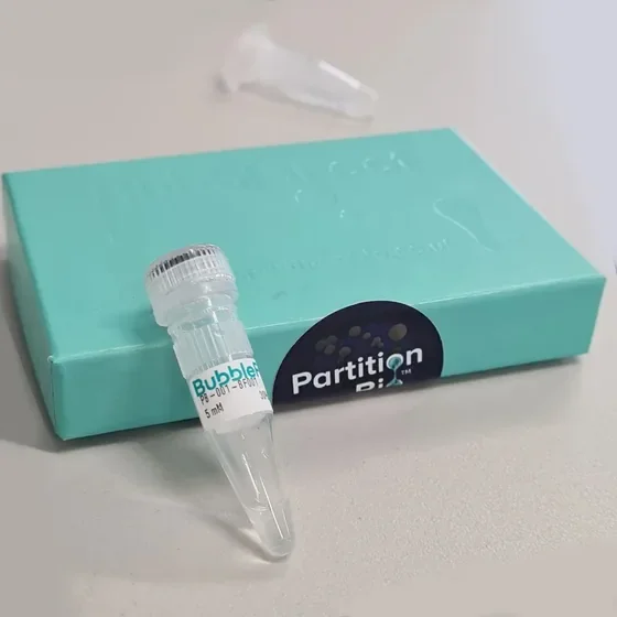 BubbleFect reagent vial leaning against a teal Partition Bio product box on a laboratory bench