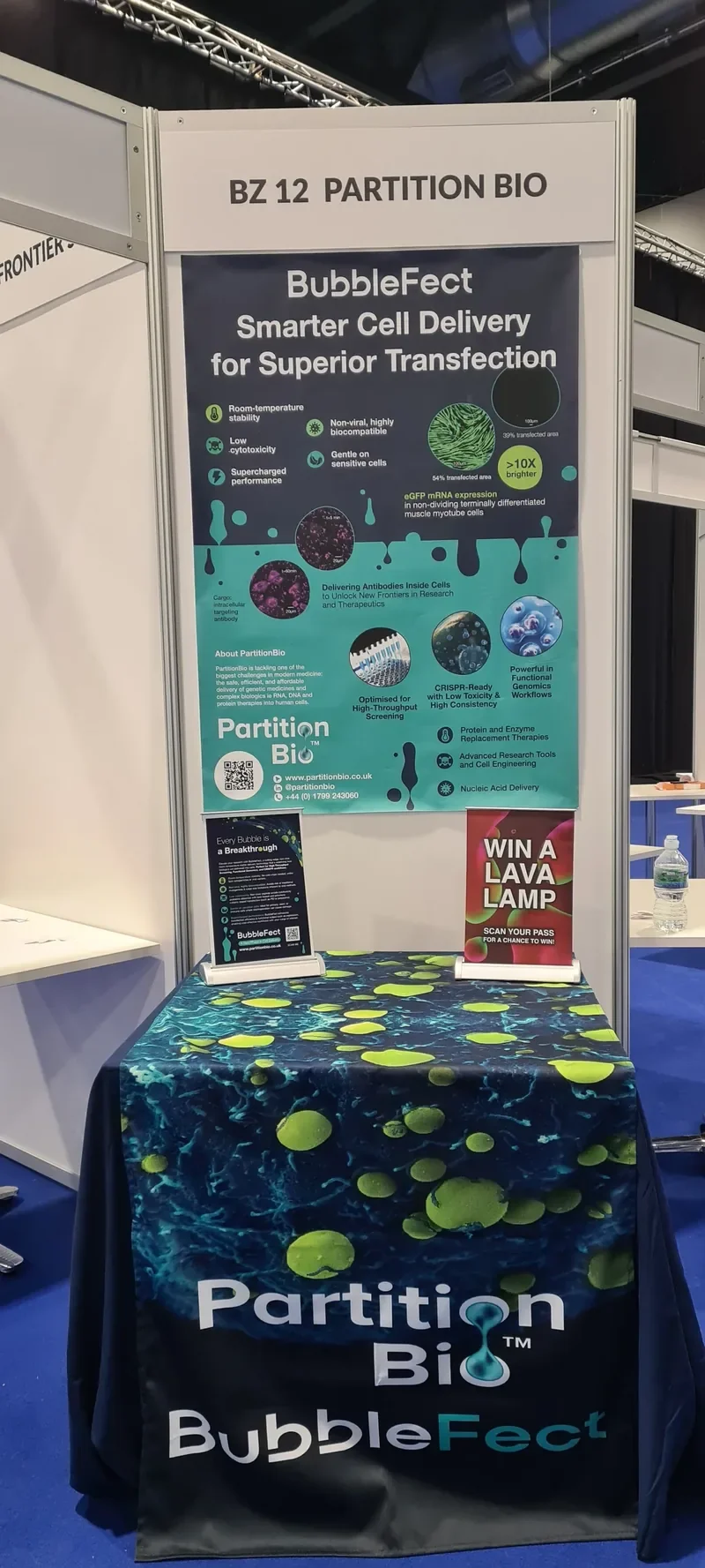 artitionBio BubbleFect stand BZ12 fully dressed at ELRIG Drug Discovery 2025 Breakthrough Zone, showing roller banner, branded table cloth and lava lamp competition