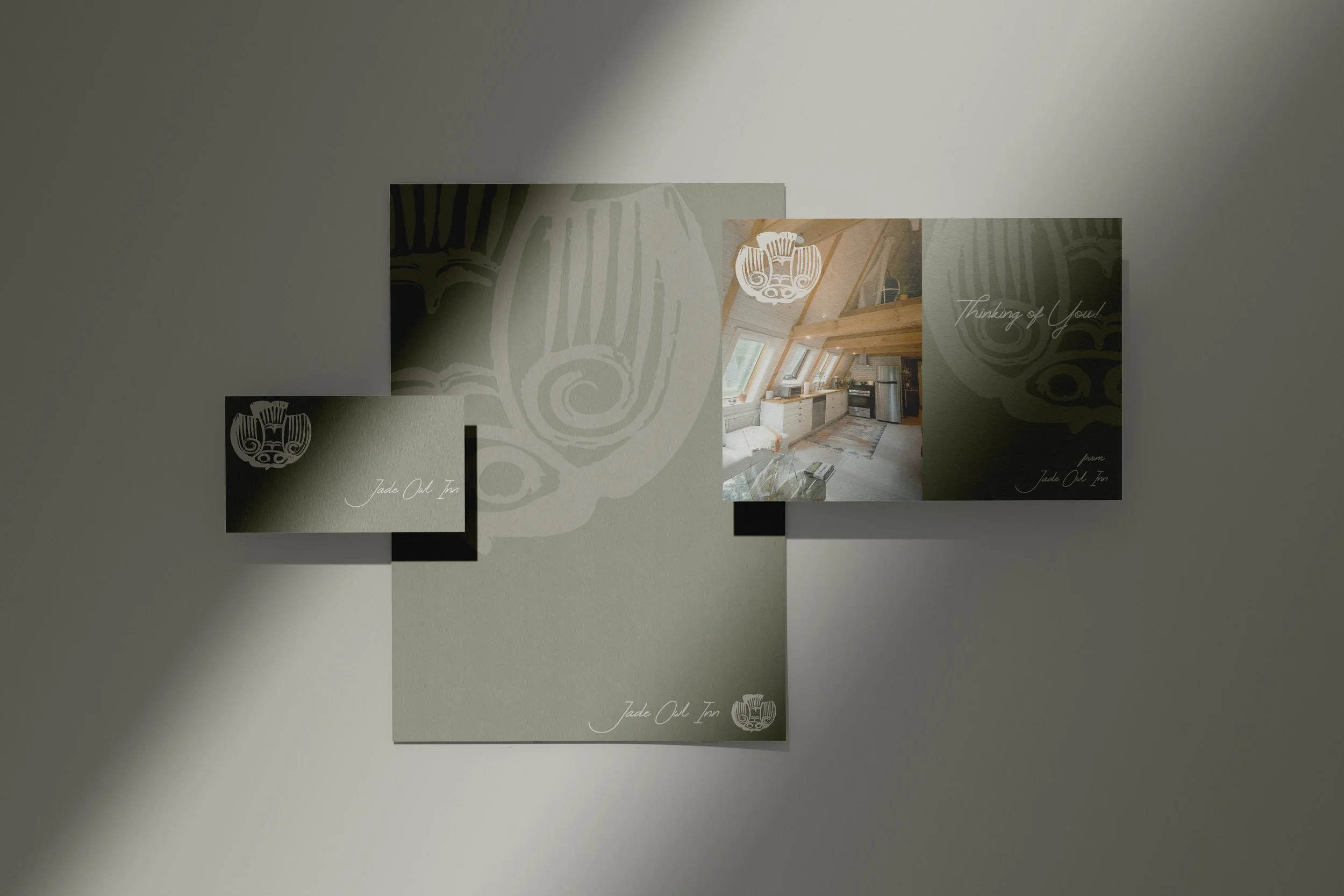 A collage of promotional materials for Jade Oak Inn, featuring a logo, interior view of a cozy room with wooden beams and a kitchenette, and handwritten-style text reading 'Thinking of You!'.