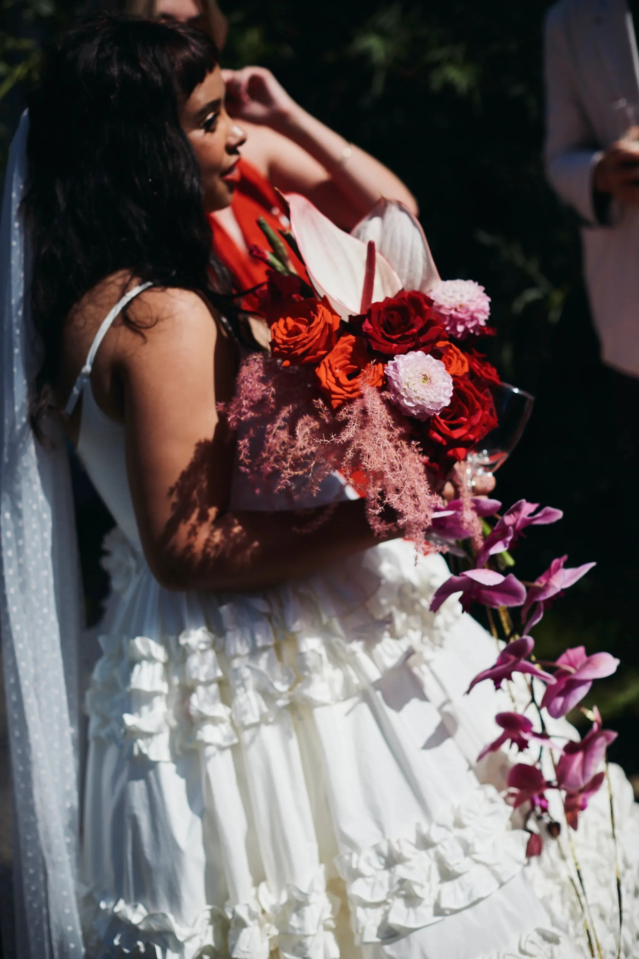 XL contemporary bridal bouquet composed of pink and red flowers with cascading orchid, anthuriums, dahlias and luxury roses