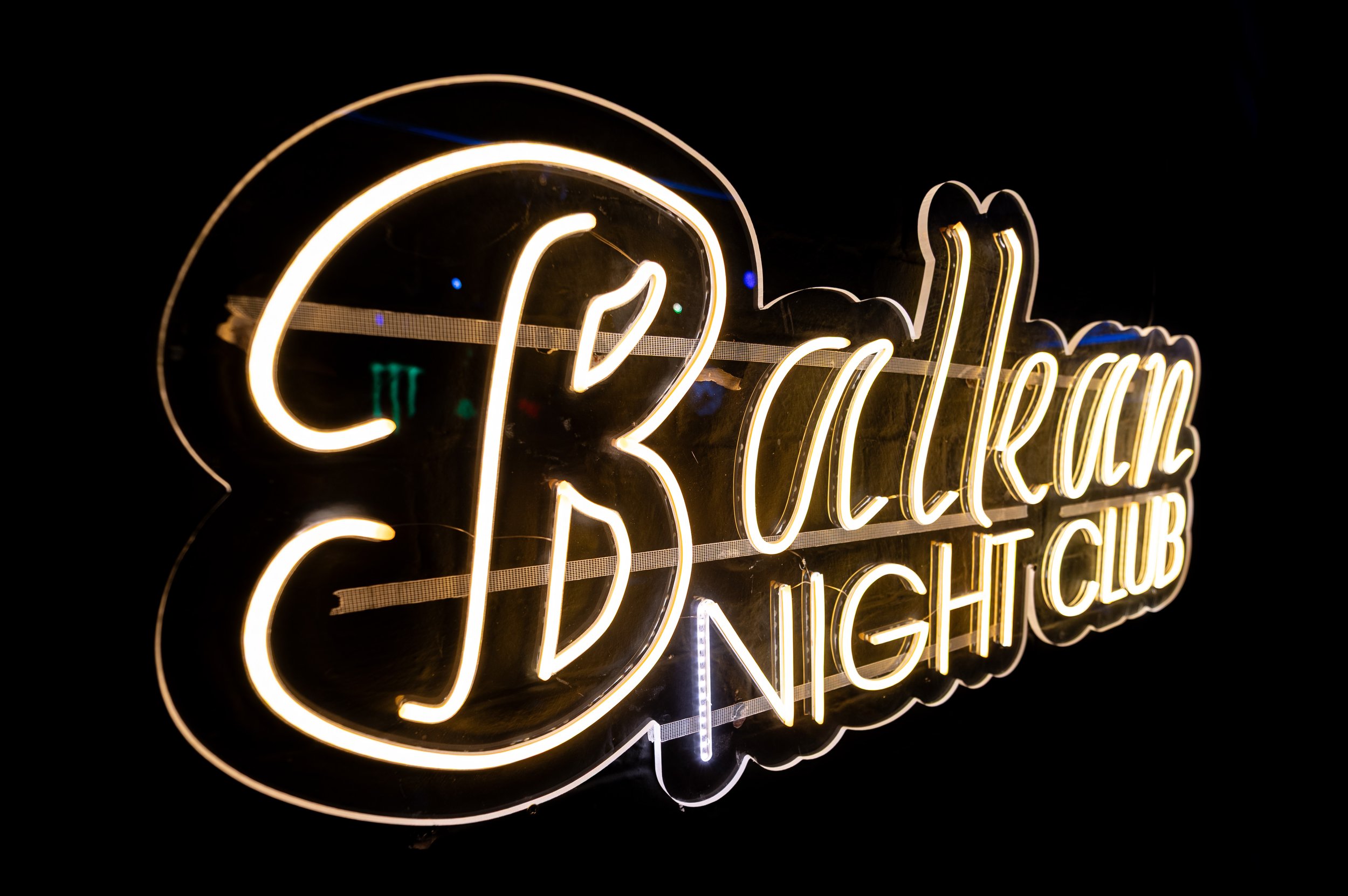 A neon sign advertising "Balkan Nightclub"