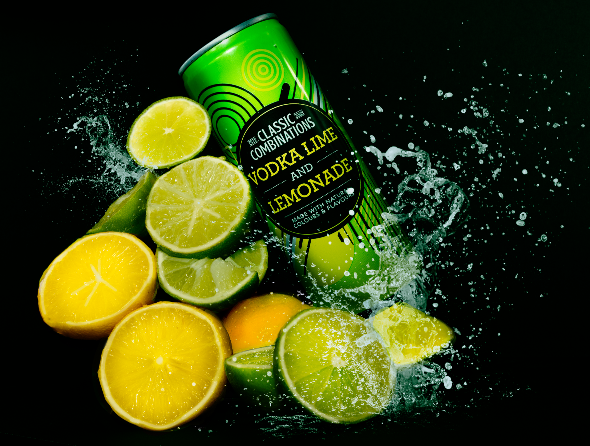 Can of vodka lime and lemonade mixer surrounded by sliced lemons and limes, with splash effects, on a black background.