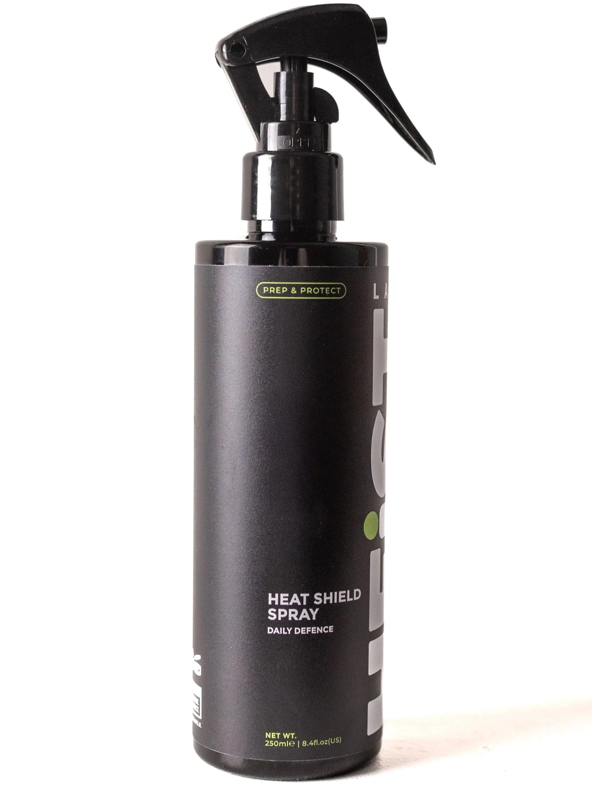 A black spray bottle labeled 'Heat Shield Spray' with a nozzle, used for hair styling, with additional text 'Daily Defence' and '250ml | 8.4 fl oz (US)'.