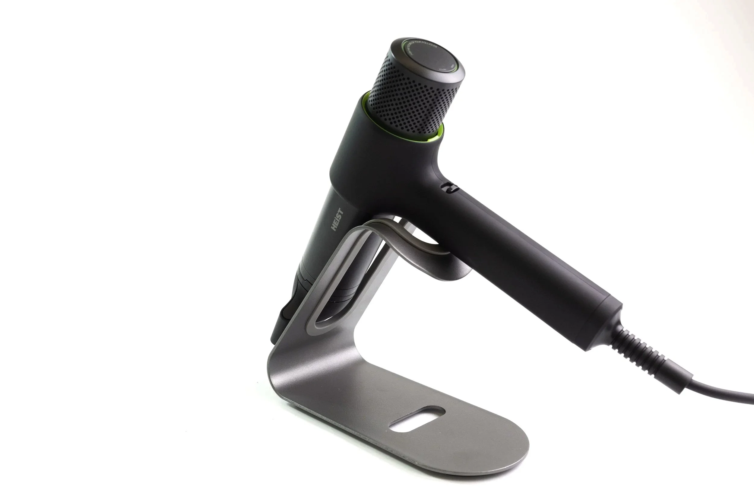 A hairdryer placed on a metallic stand with a white background.
