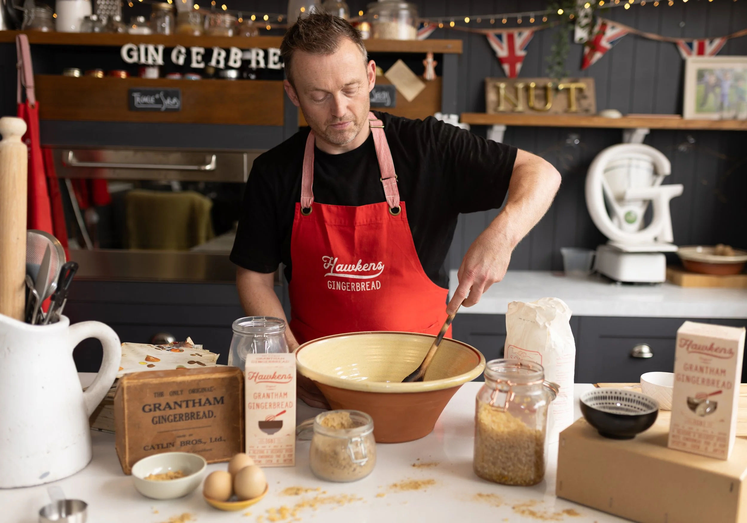 Lifestyle process photography showing baker mixing dry ingredients in a bowl for a high-quality product.