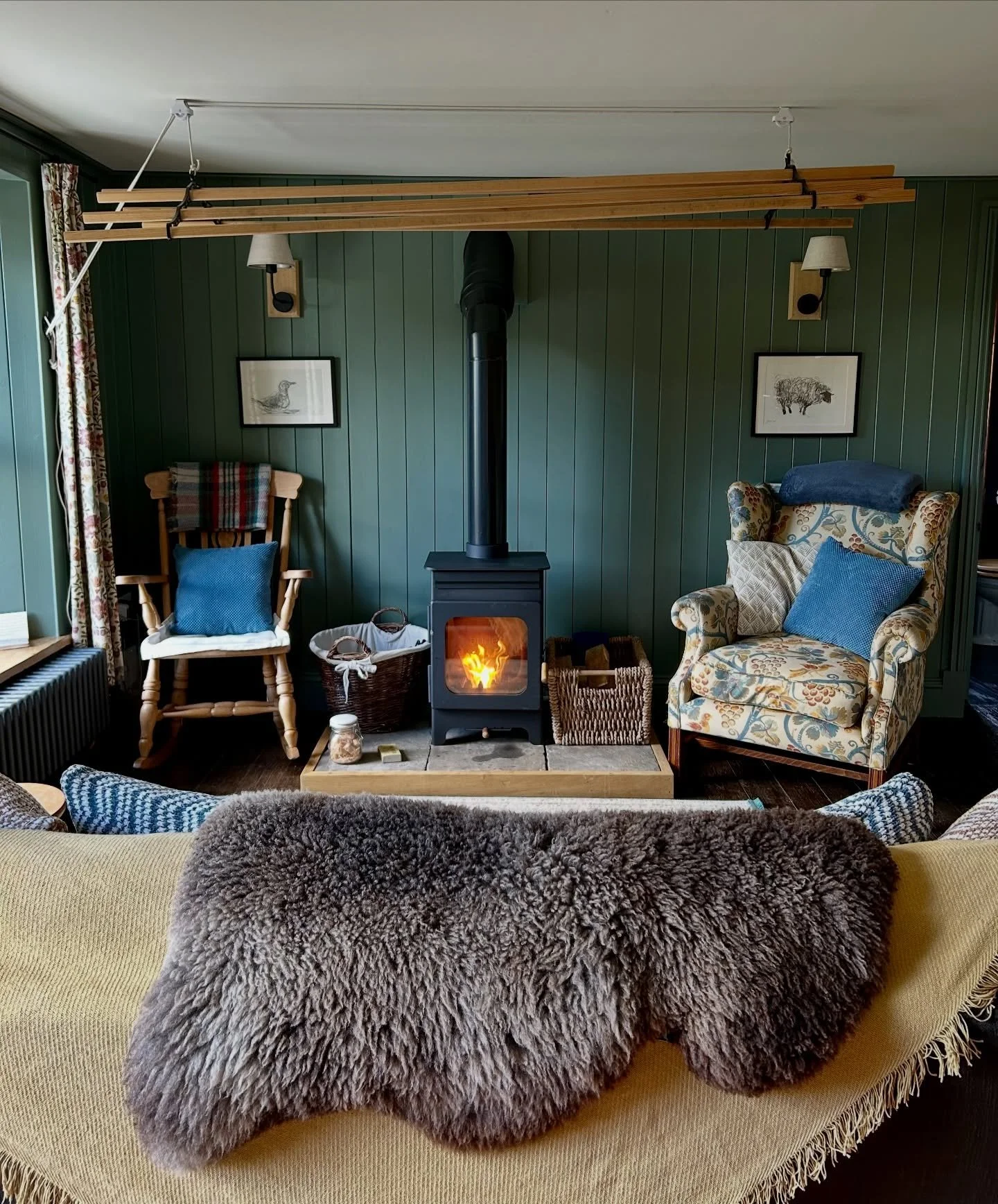 It&rsquo;s a day for cosying up in front of the fire with a cup of tea ☕️

Green Smoke by @farrowandball 
Sketches by @jason_gathorne_hardy from our Suffolk days
Wall lights by @lightingdirect but we did a DIY job and Jonny (@timber_structures) made 