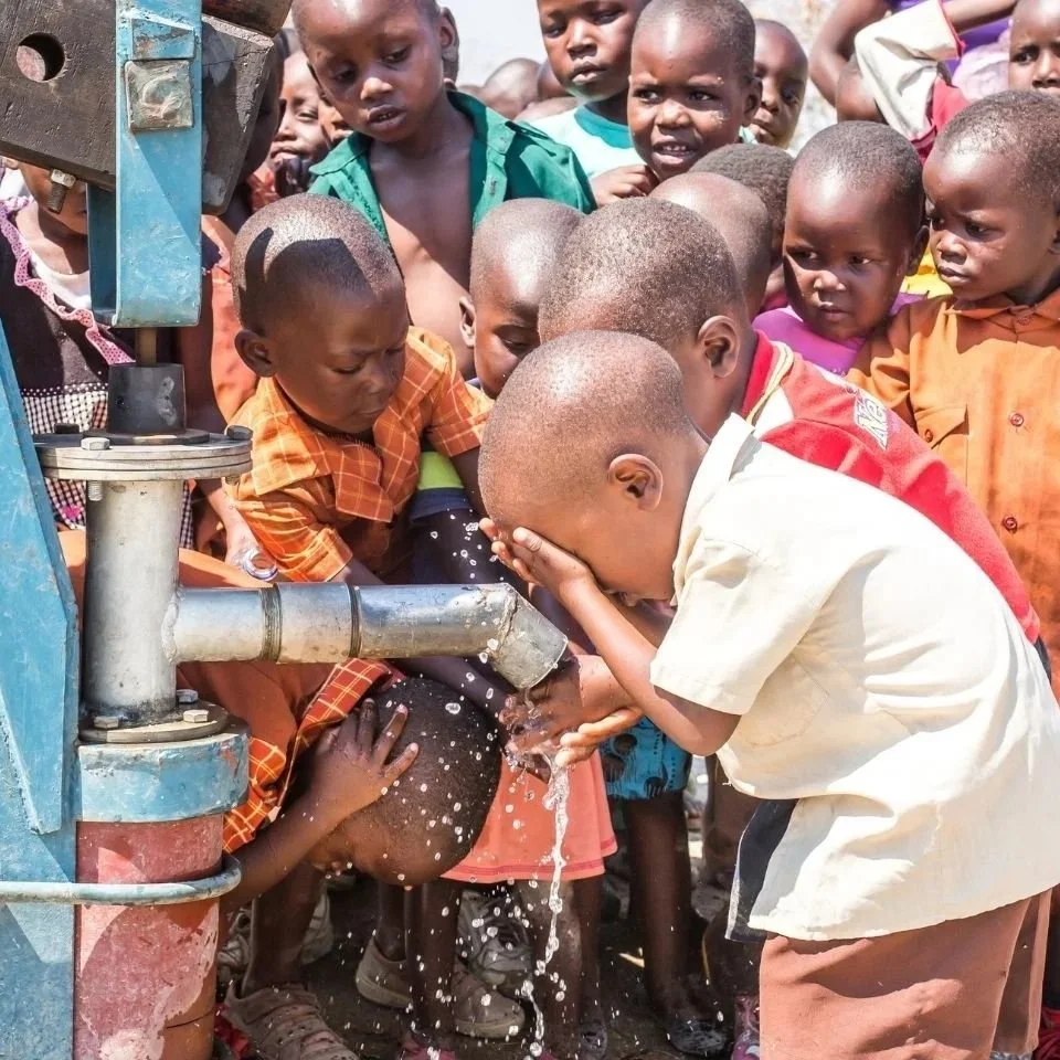 Children at water pump, Jessie's House, Zimbabwe