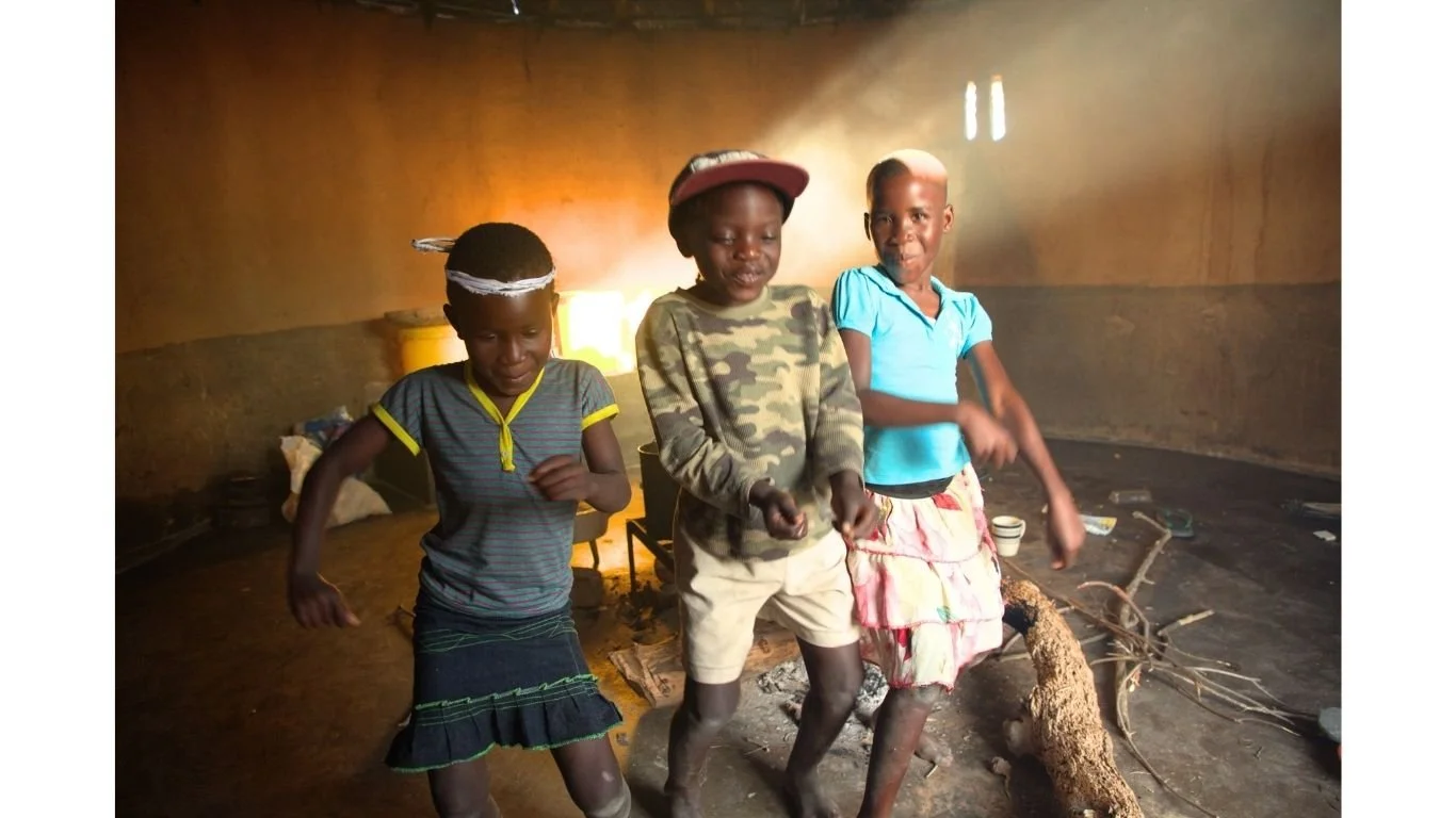 Taya inside her basic home dancing with her cousins