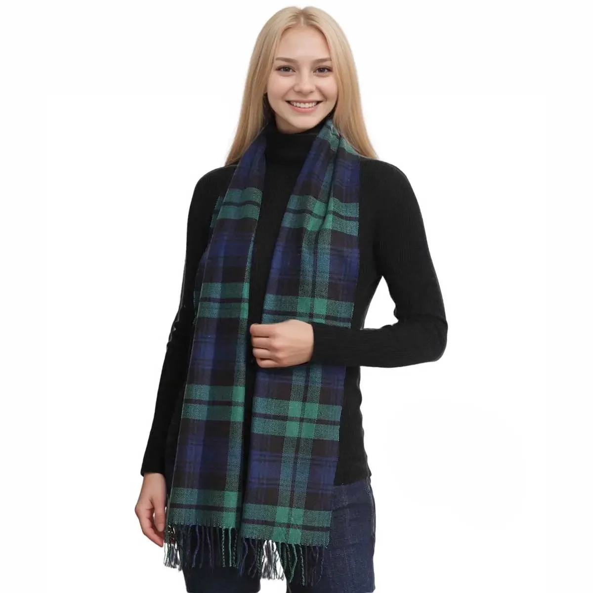 A young woman with long blonde hair smiling, wearing a black turtleneck and a green and blue plaid scarf.
