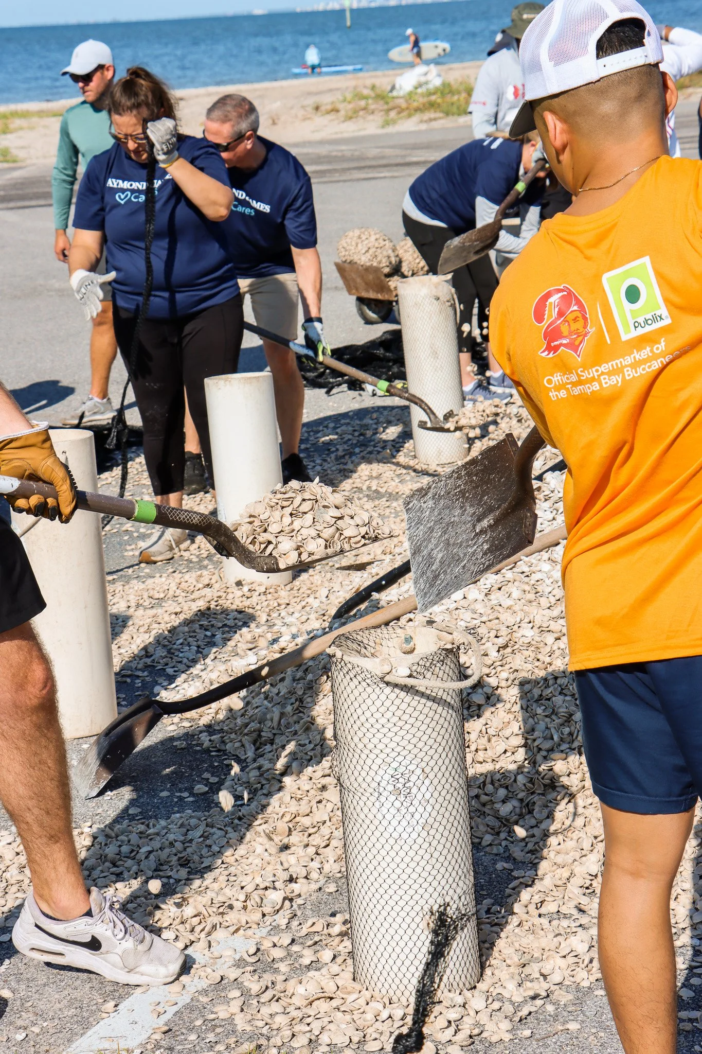 Volunteers working together to create fossilized shell bags for Living Shoreline restoration efforts in Tamps Bay Florida