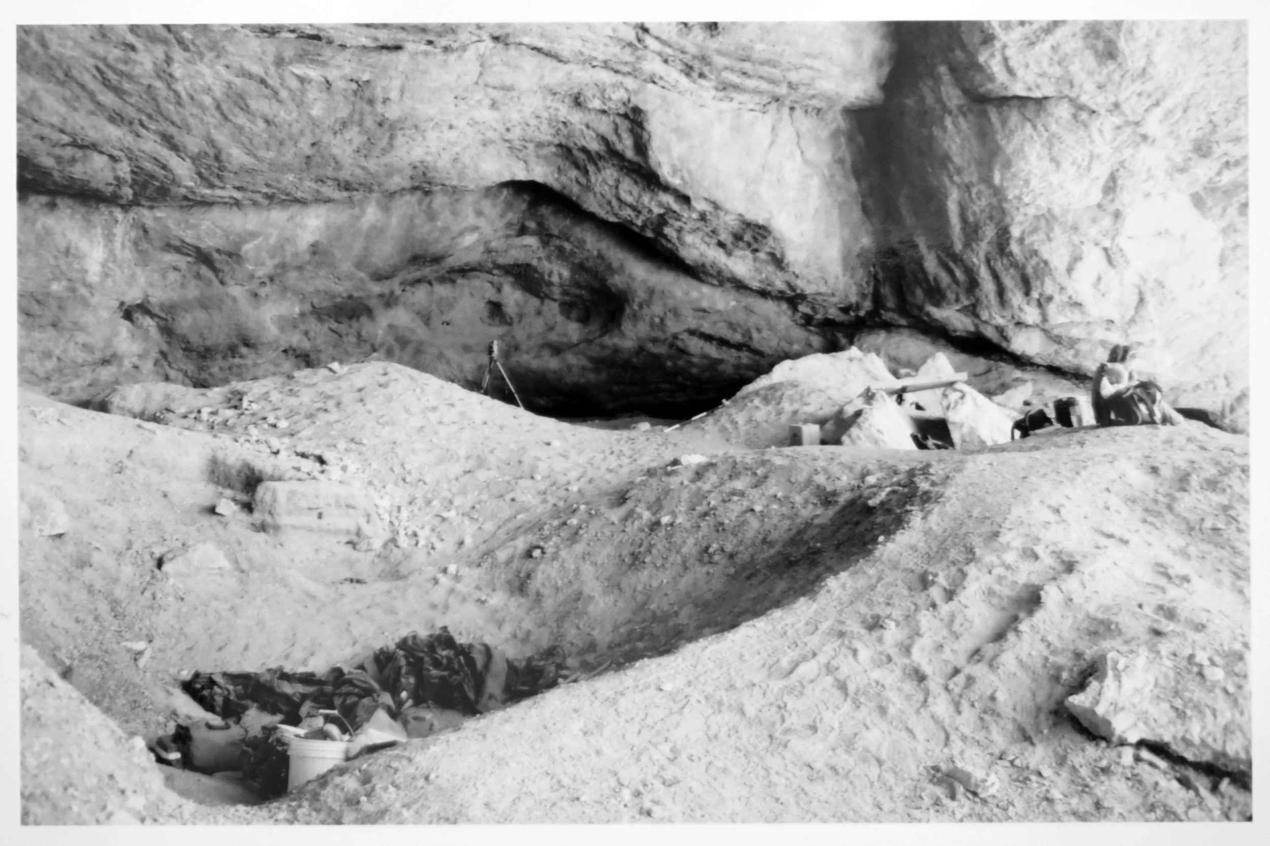 A rock shelter in Nevada with excavation tools.