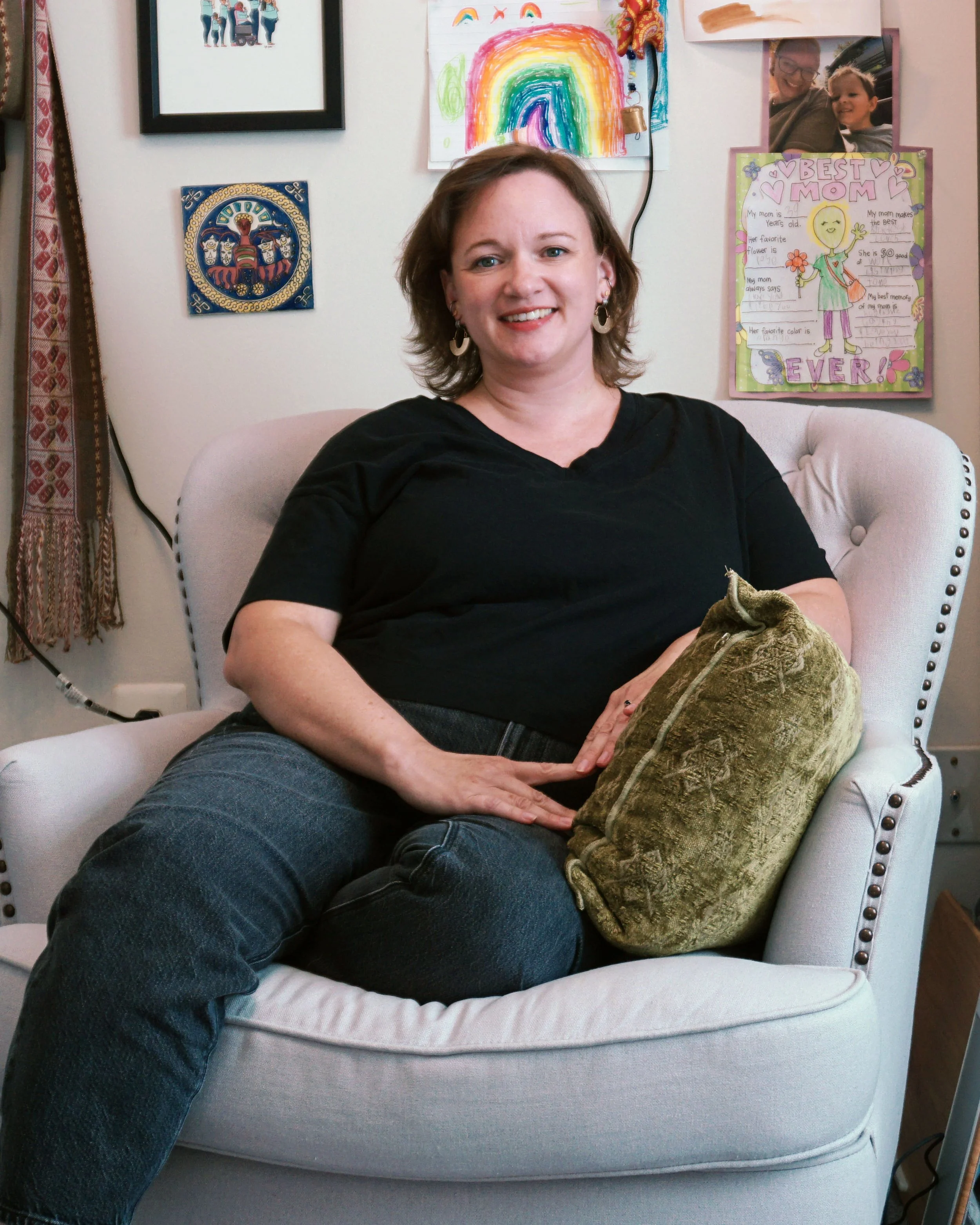 Lisa is seated in her office. She is a middle-aged white lady wearing a black shirt and jeans.