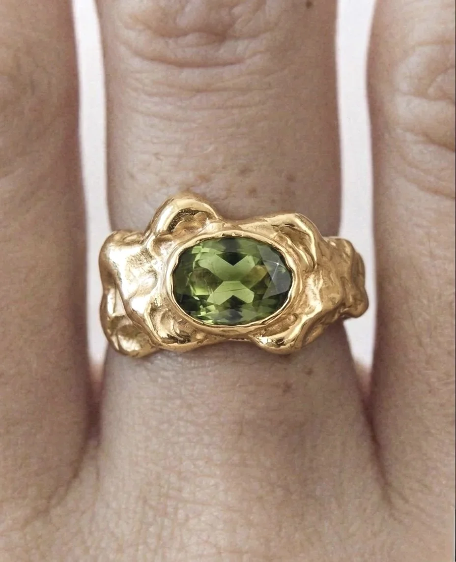 Gold Bronze ring with green gemstone made in a Culto Solar workshop